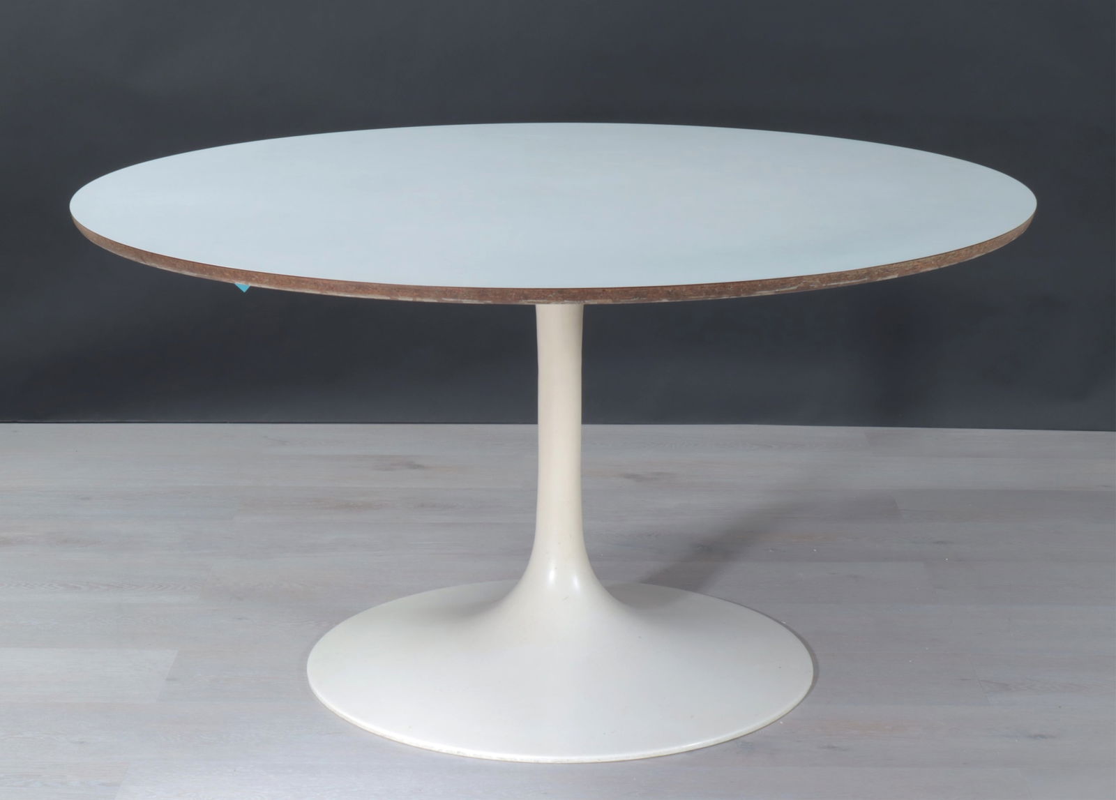 MCM Tulip Style Dining Table: Midcentury Modern Tulip style dining table, attributed to Burke, Inc., with white laminate top and white-painted metal base; unmarked. Dimensions: 29" H x 54" Dia 