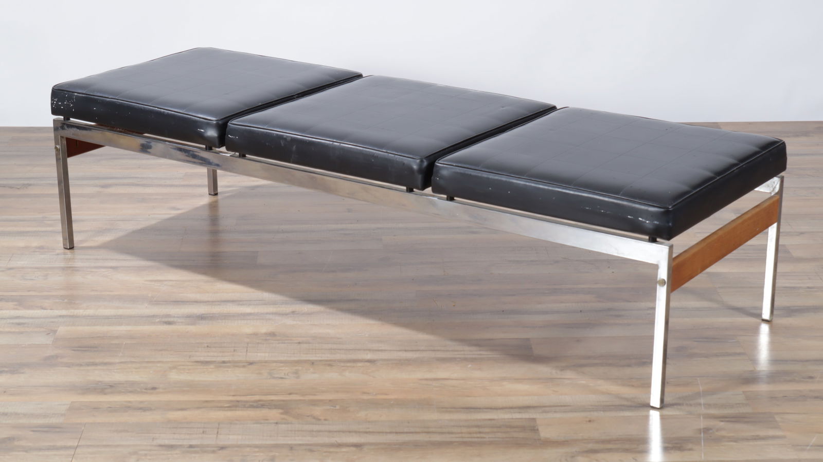 Mid-Century Modern Chrome and Teak Bench: Mid-century Modern Chrome, Teak and Black upholstered bench, style of Milo Baughman, with 3 faux leather upholstered cushions, teak ends and seat frames. Dimensions: 16 1/2" H x 64 1/2" L x 22 1/2" D