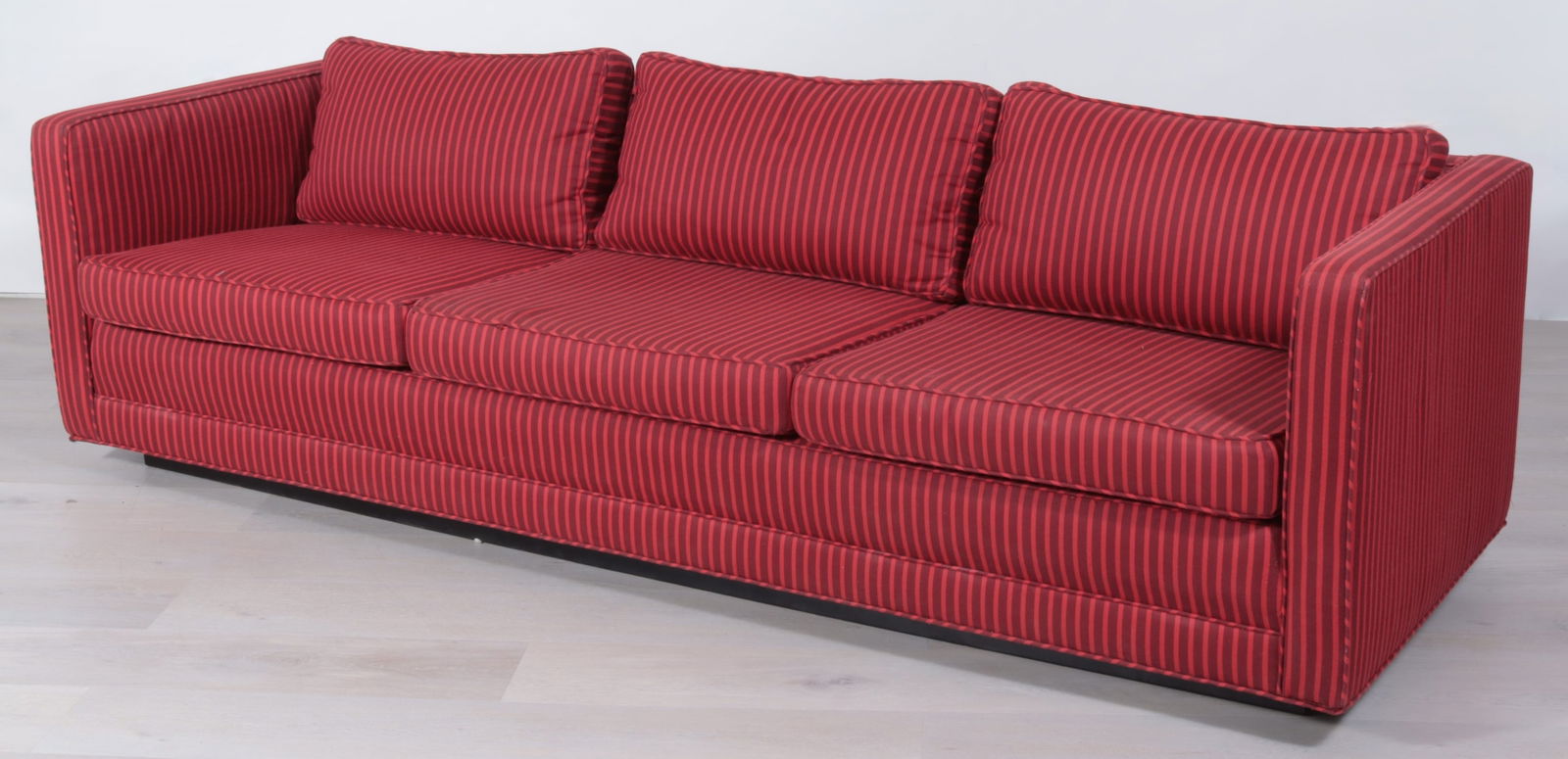 Edward Wormley for Dunbar Tuxedo Sofa: Edward Wormley for Dunbar Red striped Tuxedo sofa in Red striped fabric, c.1970, foam and fiber filled cushion, wood plinth platform. Dimensions: 29"H x 97"W x 37"D From a Washington Connecticut Home