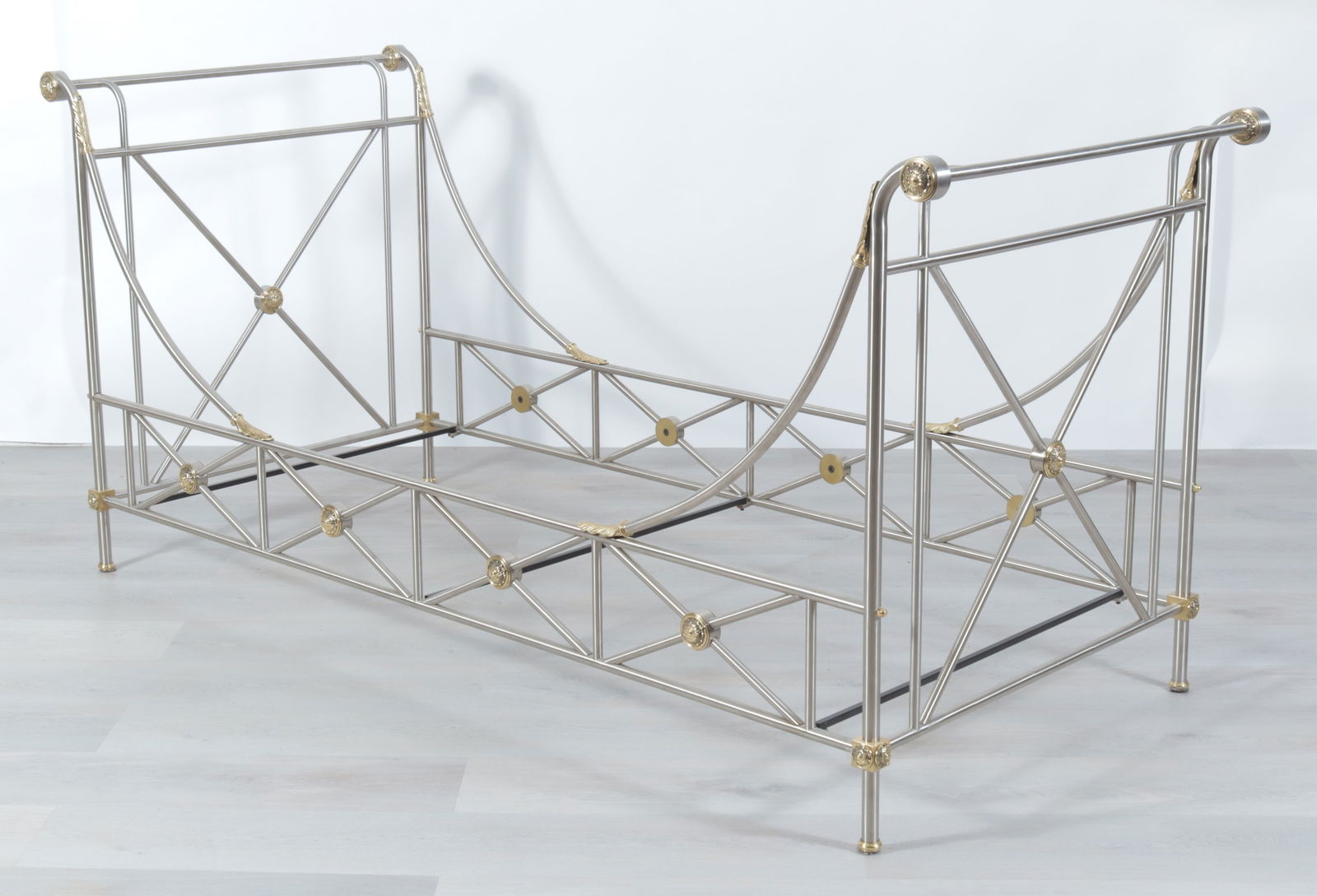 Maison Jansen Brass and Brushed Nickle Daybed: Maison Jansen brass and brushed nickel daybed, circa 1960s. Identical X-form head and foot boards with central brass medallions, swooping side rails terminating in acanthus leaves. Stamped Made in Ita