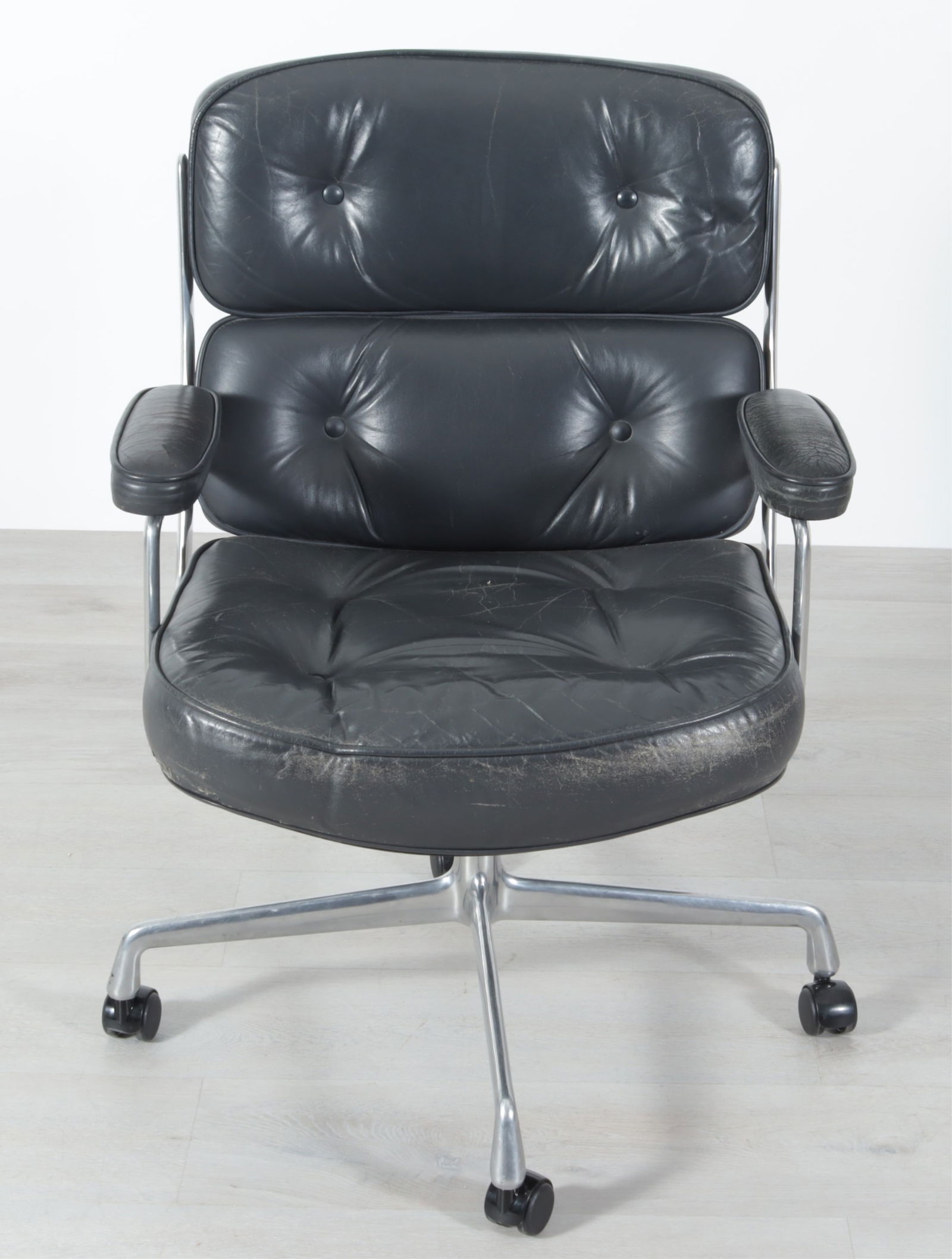 Eames for Herman Miller Executive Chair: Ray and Charles Eames for Herman Miller Time Life Executive Chair, c. 1986, dark grey tufted leather button back and padded arms, 4 star swivel base Dimensions: 36 1/2"H x 26 1/2"W x 27"D, seat height