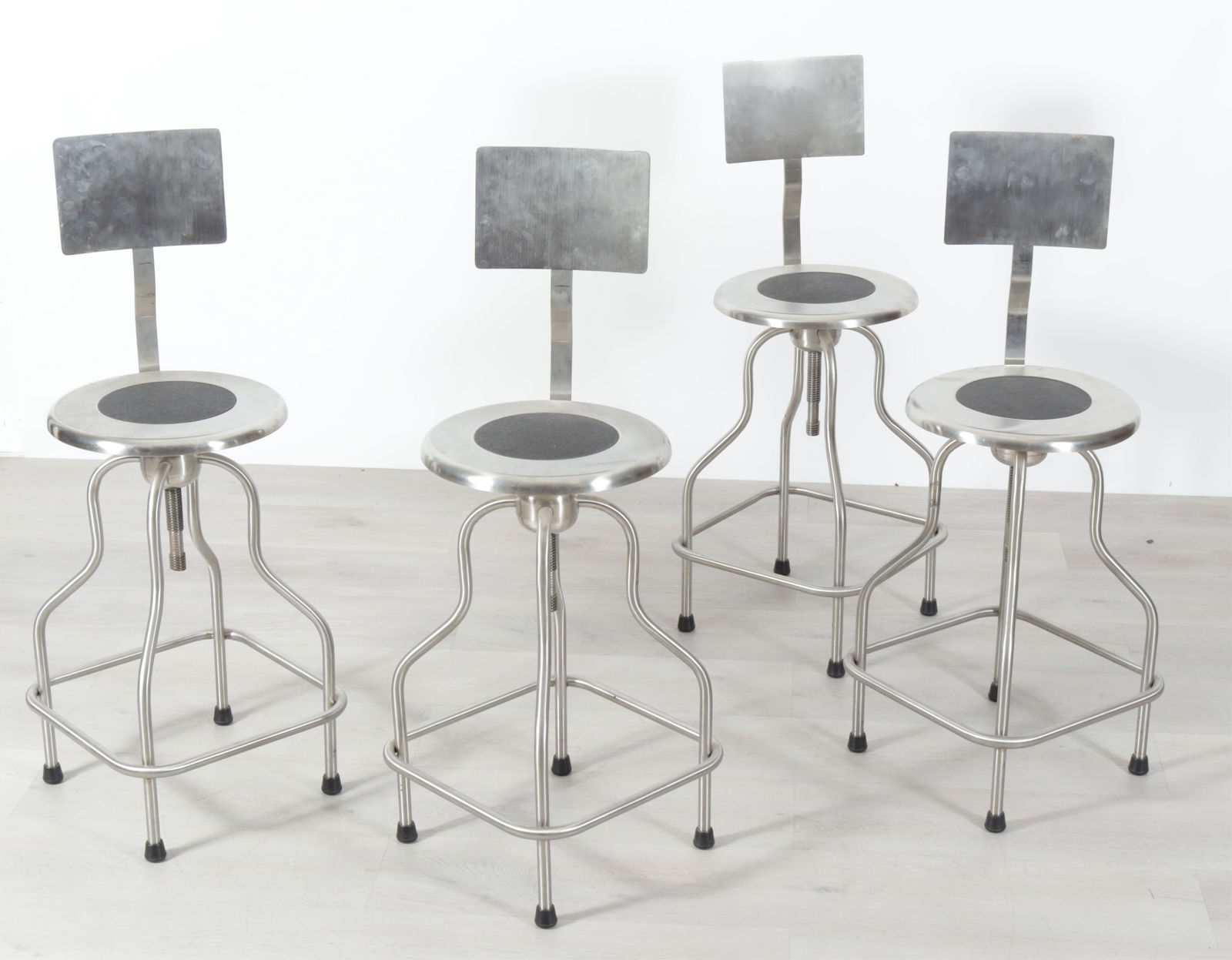 Four Design Within Reach Precision Bar Stools: Four Design Within Reach 'Precision' stainless steel bar stools with backrests. Dimensions: 40" H x 14" Dia.