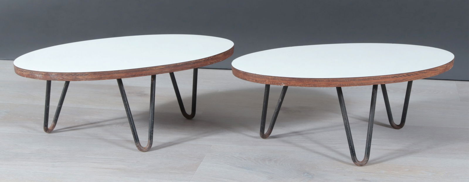 Pr Eames Herman Miller Style Mini Surfboard Tables: Pair of miniature Eames for Herman Miller Style "Surfboard" Tables, second half 20th century, each on three iron hairpin legs. Dimensions: 8 1/2" H x 20-7/8" W x 12" D 