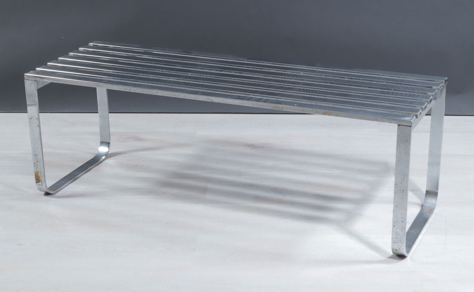 Milo Baughman Chrome DIA Bench: Milo Baughman Chrome DIA bench, the top with 7 slats, rounded-end bases, with DIA label. Dimensions: 16 1/2" H x 48" W x 16 1/2" D 