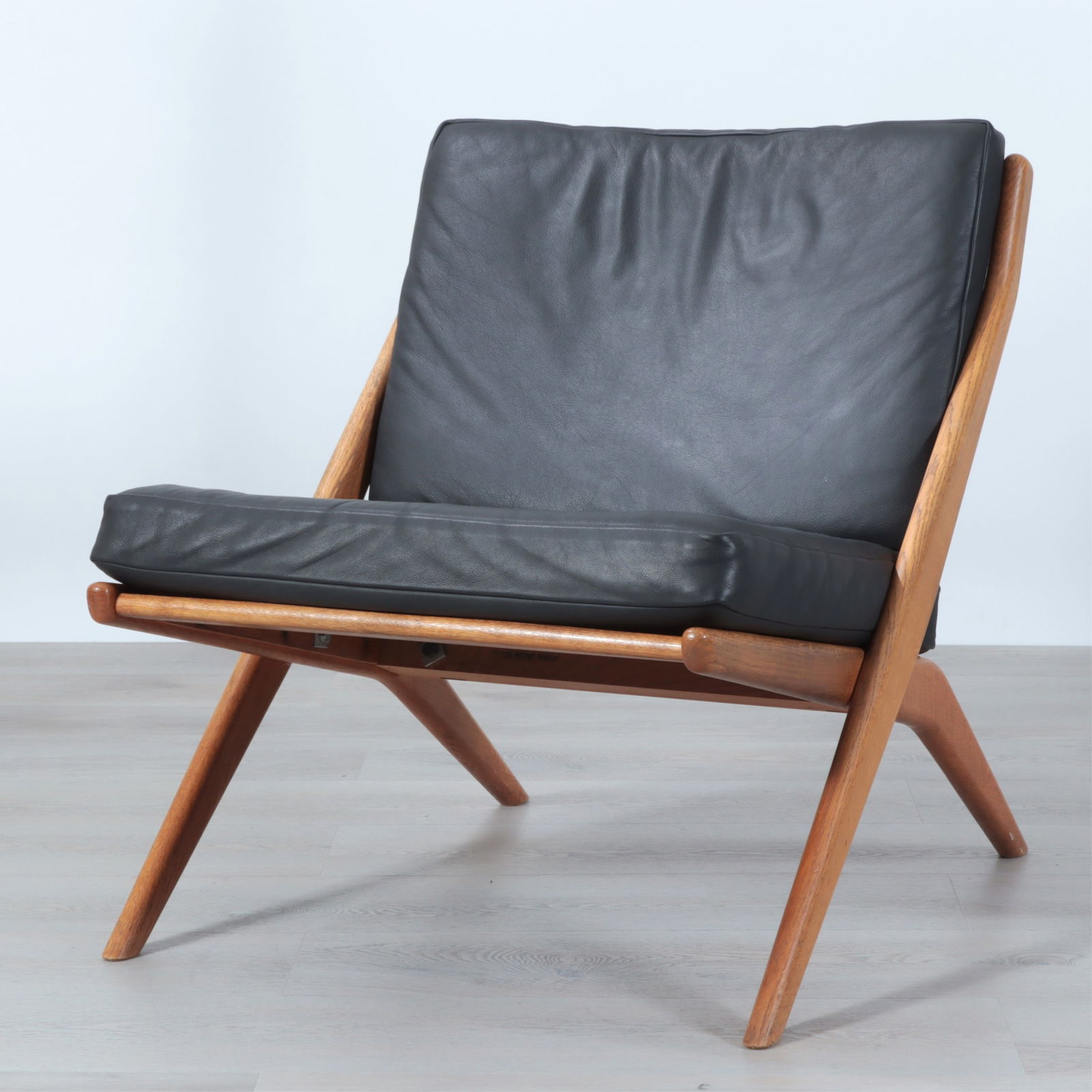 Folke Ohlsson for Dux Scissor Chair c.1950: Folke Ohlsson (Swedish, 1919-2002) for Dux Scissor Chair, c. 1950, wood and leather, original production, marked "DESIGN PATENT PENDING" Dimensions: 27 3/4? Frame (29 1/2? top of cushion) x 25 1/2 ?W