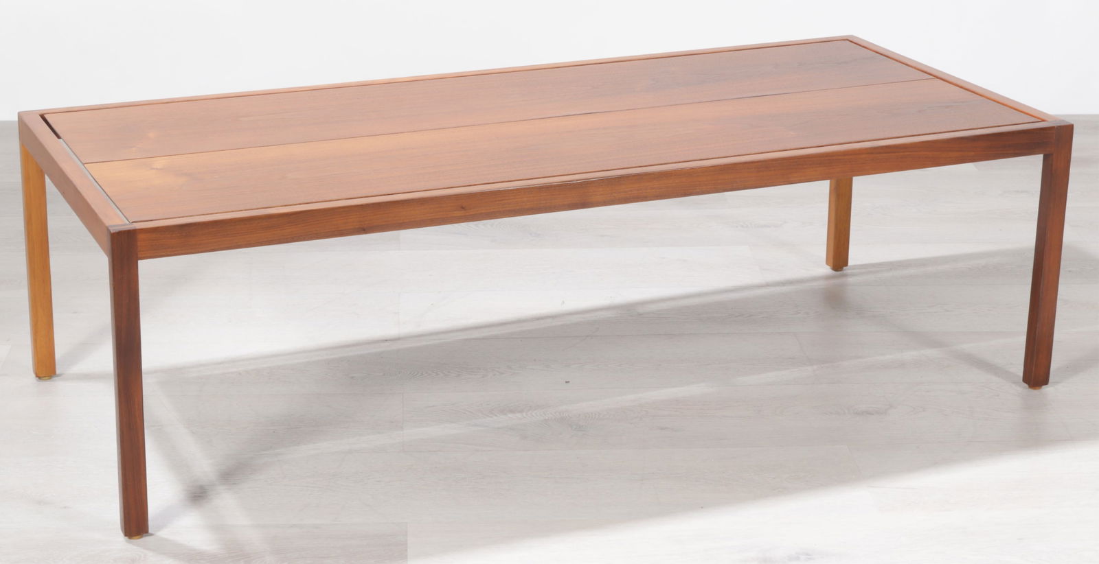 Lewis Butler for Knoll Walnut coffee table: Lewis Butler for Knoll, c. 1950-1960, walnut rectangular coffee table, Knoll label affixed to base Dimensions: 16 H x 54 W x 24 D Property of a New York Architect and Designer