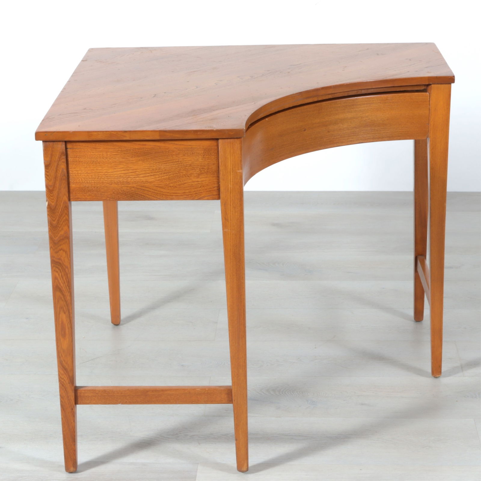 Mid-Century Modern Oak Corner Desk: Mid century Modern, possibly Heywood Wakefield, oak corner desk, c.1950, interior drawer with fitted compartment Dimensions: 34" D along each wall side, 29" H, corner to inner curve 29 5/8 Property