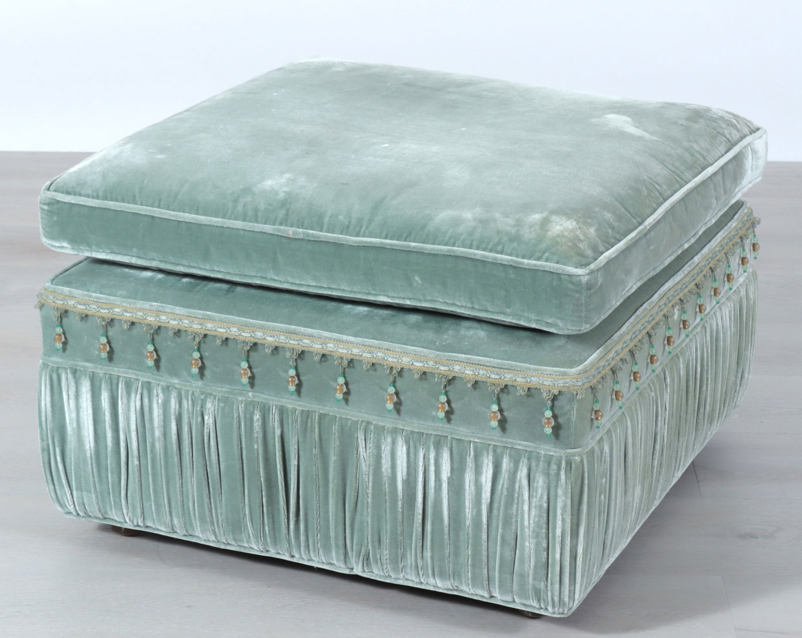 Contemporary Upholstered Ottoman: Contemporary Upholstered Ottoman, with beaded fringe, upholstered in light-green velvet. Dimensions: 20" H x 28" Square Property from the Estate of Mary C. Bailey