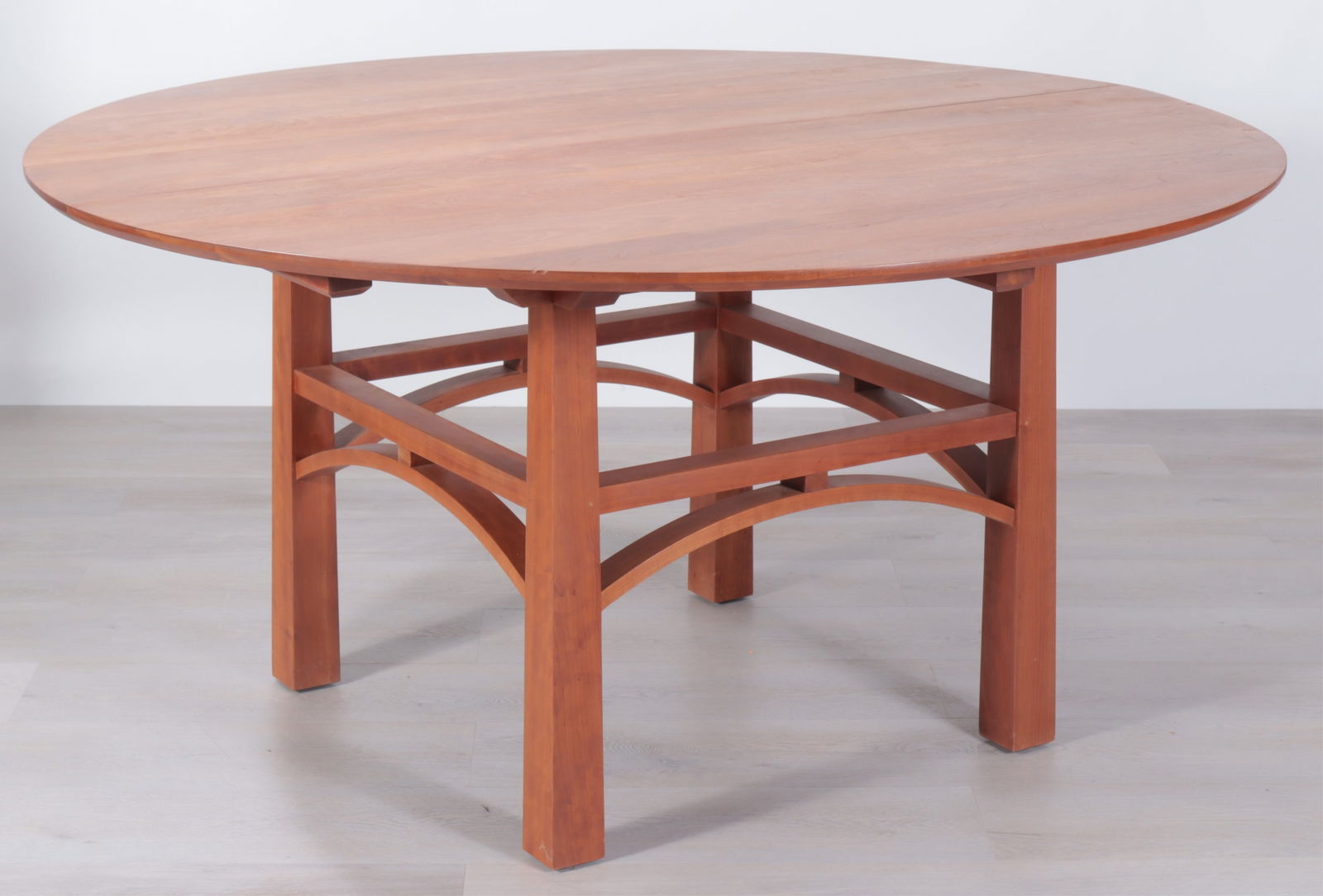 Thomas Moser Bungalow Table, circa 2000: Thomas Moser Bungalow Cherry Extension Dining Table, signed and dated 2003, with one leaf Dimensions: 29.5" H x 60" Dia., Leaf 21.75" L From a Washington Connecticut Home