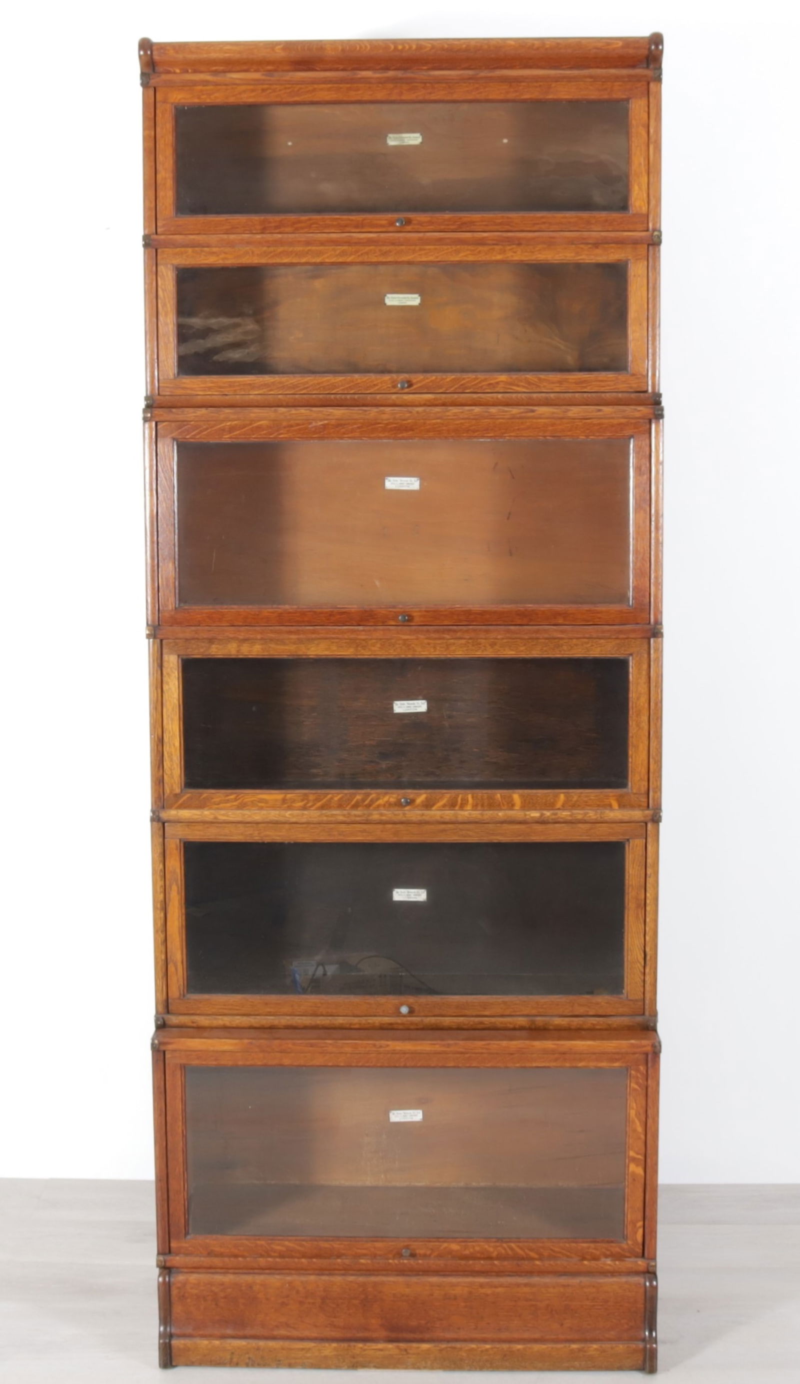 Globe Wernicke Oak Barrister Bookcase: Six stack of Globe Wernicke Oak Barrister Bookcase. The Globe - Wernicke co. ltd. Office and Library Furnishers LONDON. Label adhered on inside. Six graduating cabinets with recessing lift front