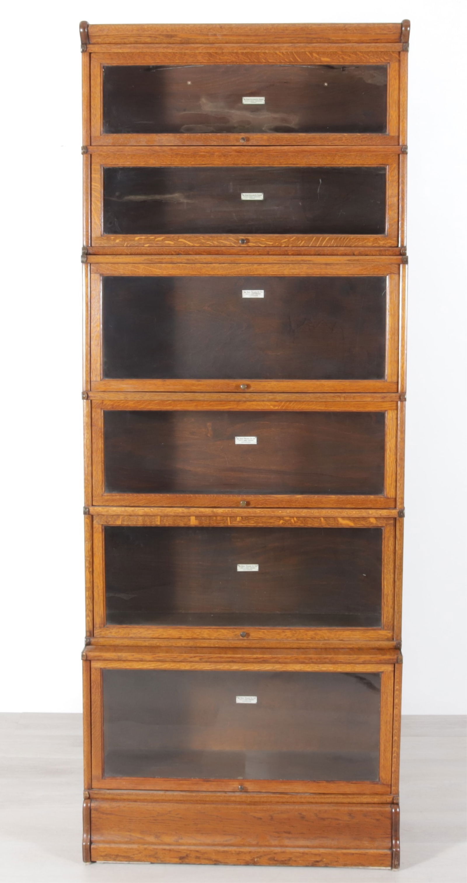 Globe Wernicke Oak Barrister Bookcase: Six stack of Globe Wernicke Oak Barrister Bookcase. The Globe - Wernicke co. ltd. Office and Library Furnishers LONDON. label adhered on inside. Six graduating cabinets with recessing lift front