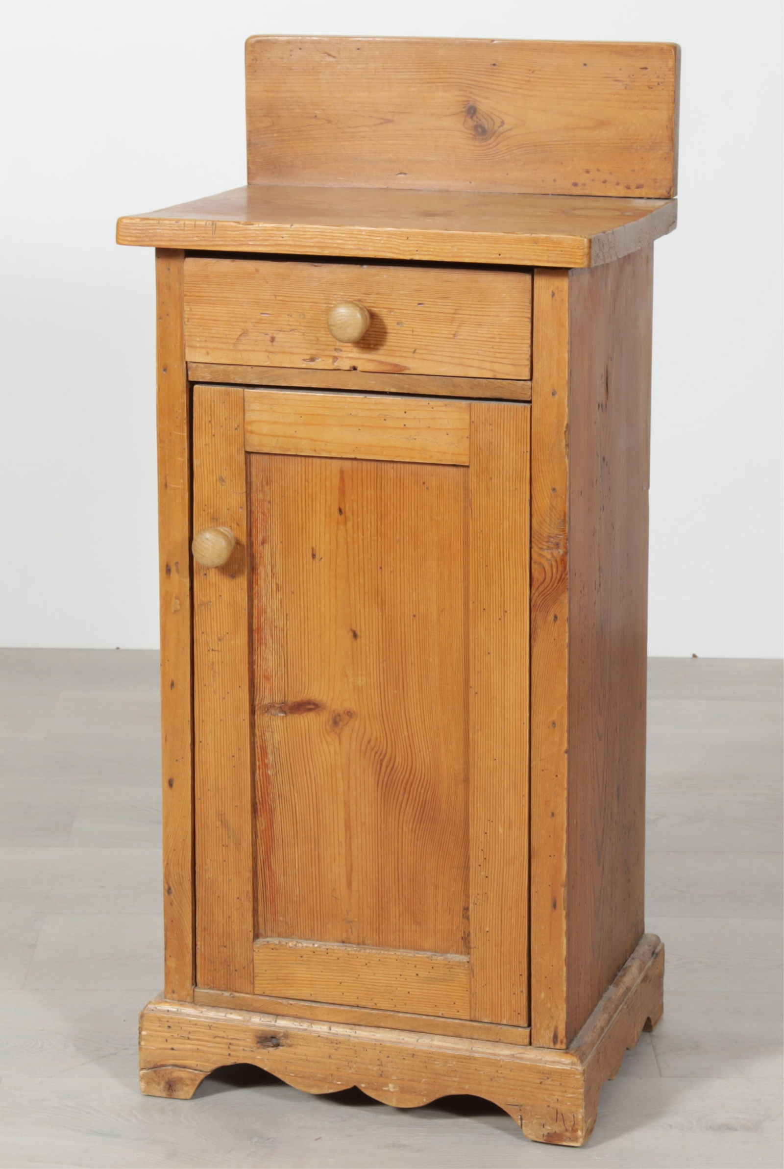 Country Pine Bedside Cabinet: Country Pine Bedside Cabinet. Single drawer over door enclosing single shelf, with wooden knob pulls. Dimensions: 37.25" H x 16.5" W x 13.75" D 