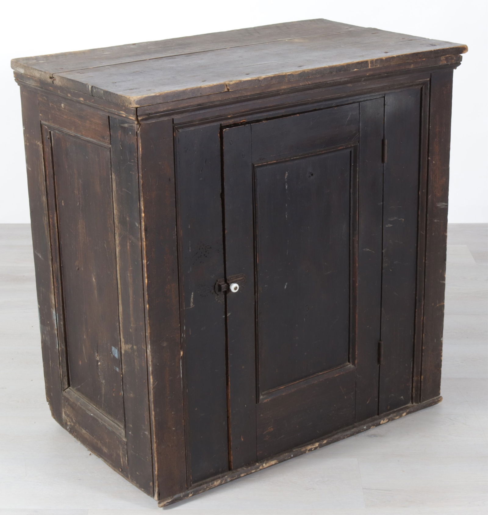 Country Black Painted Pine Cabinet: Country Black Painted Pine Cabinet. Single door enclosing two shelves with milk glass door knob. Dimensions: 36.5" H x 36" W x 21" D 