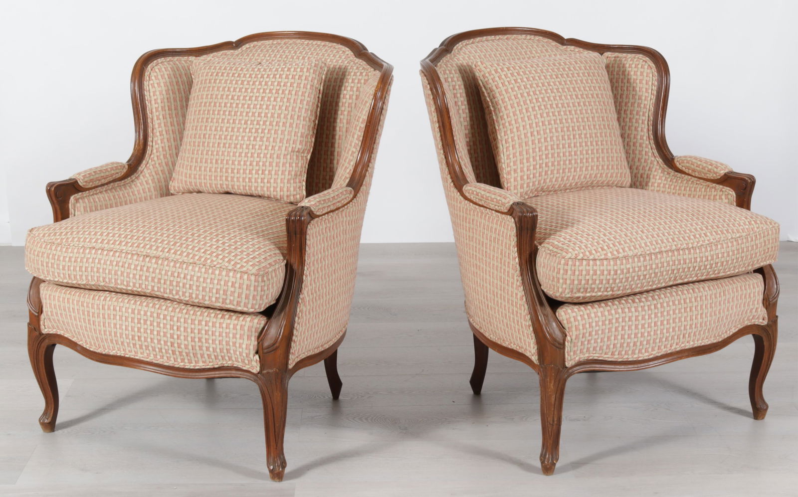 Pair of Louis XV Style Bergeres: Pair Louis XV Style Beechwood Stained Bergeres, in green and red brocade upholstery Dimensions: 34.5" H x 27" W x 36" D 