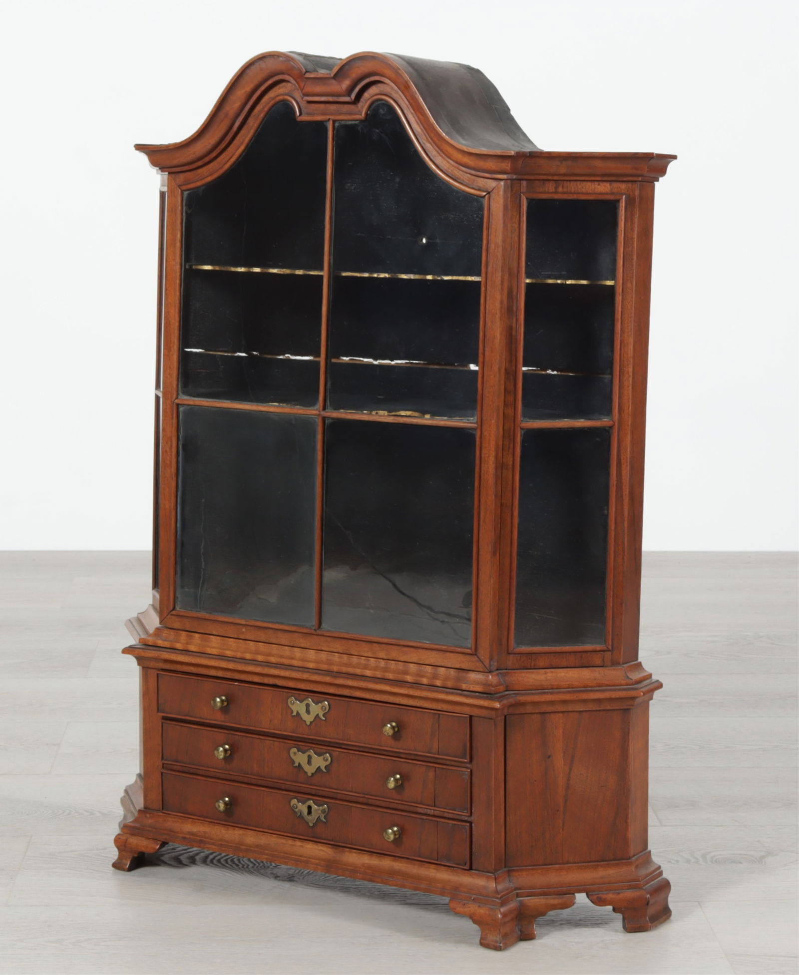 Dutch Baroque Style Walnut Diminutive Vitrine: Dutch Baroque Style Walnut Diminutive Vitrine, 20th C. Arched molded cornice above a glazed front and glazed canted side, over three drawers, on bracket feet. Dimensions: 29.5" H x 21.5" W x 5.5" D 