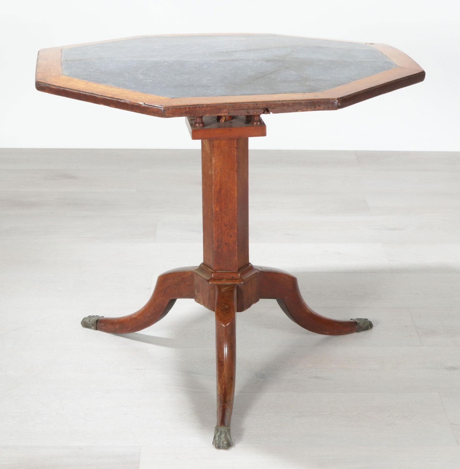 Directoire Walnut Tripod Table: Directoire walnut tripod table with inset grey slate octagonal top and paw feet. Dimensions: 26.25" H x 29.5" W