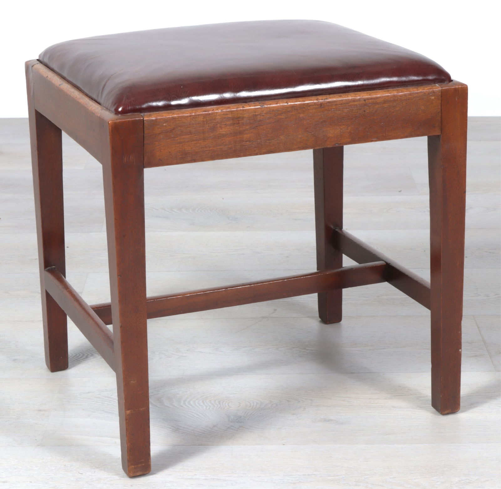 George III Mahogany Bench, 18th C.: George III Mahogany Bench, 18th C., in burgundy leather upholstery Dimensions: 19" H x 18" W x 18" D 