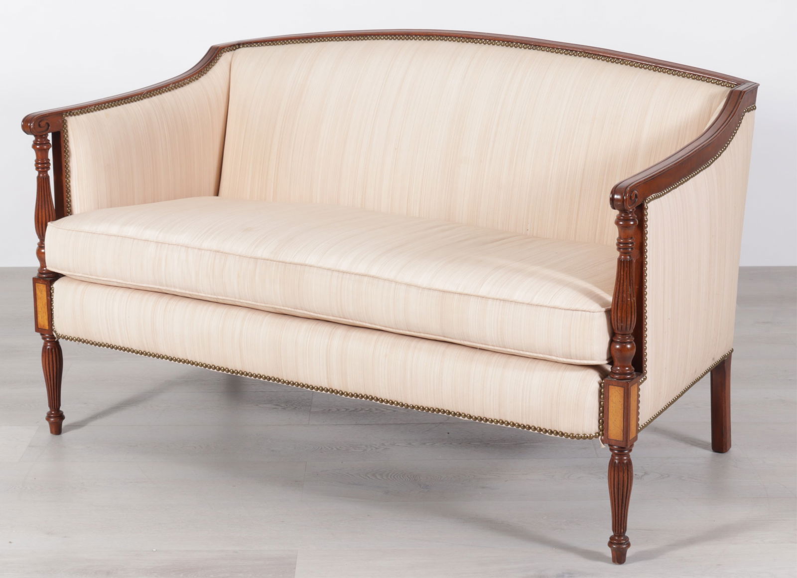 Federal Style Inlaid Mahogany Settee: Federal Style Inlaid Mahogany Settee, upholstered in salmon fabric, arched crest with brass tacked trim, reeded baluster posts and baluster legs. Dimensions: 33.5" H x 53.25" W x 31" D 