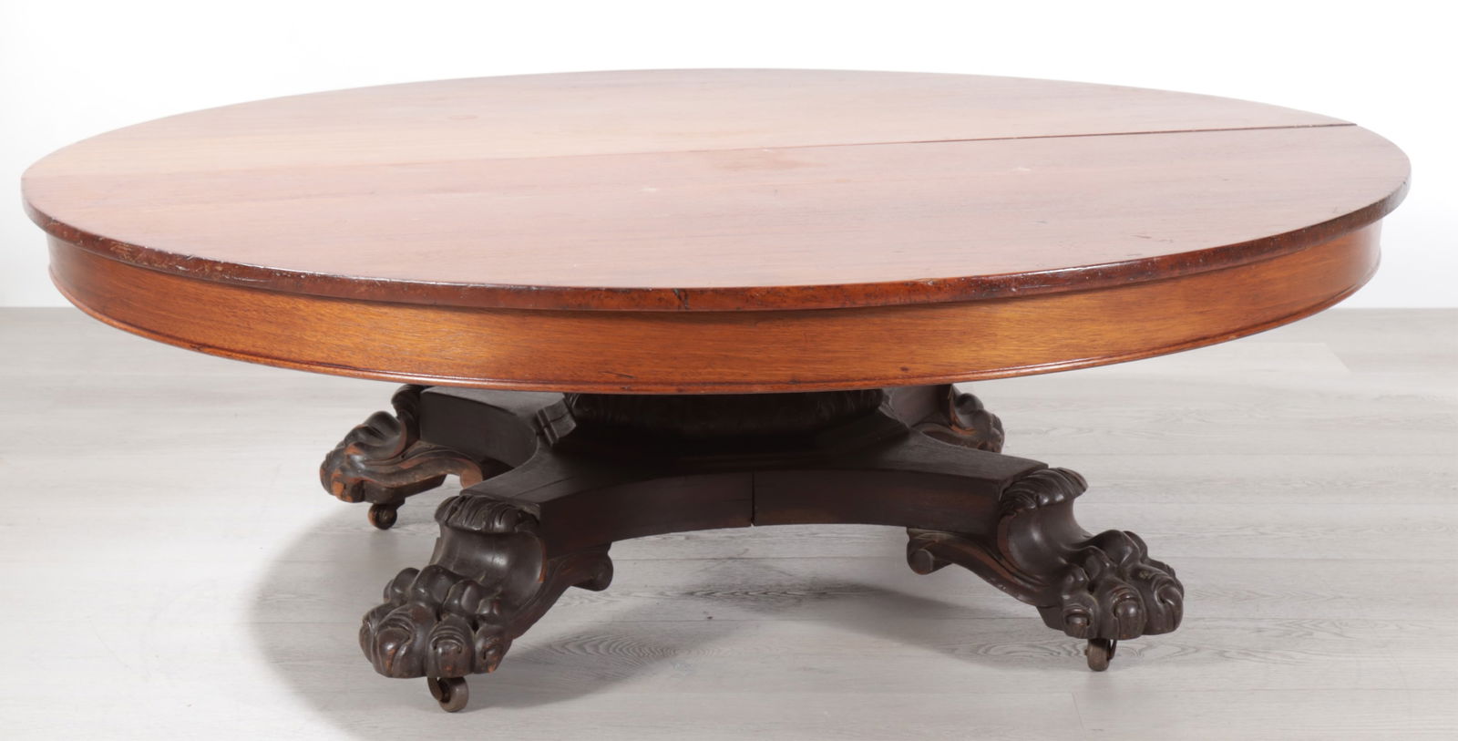 Classical Style Mahogany Coffee Table: Classical Style Mahogany Coffee Table, originally a dining table, large paw feet. Dimensions: 19" H x 54" Diameter. 