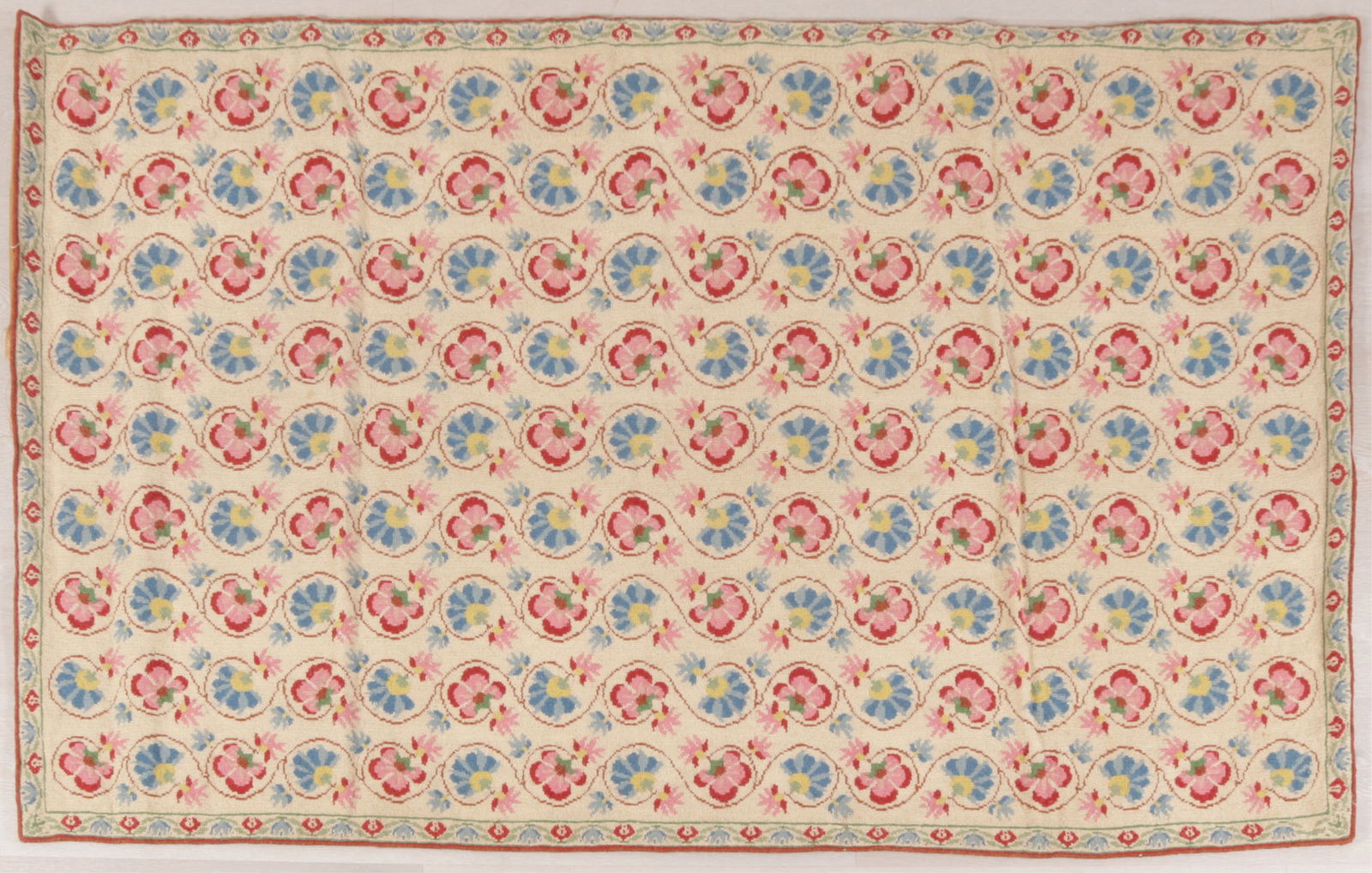 Country Floral Wool Stitched Rug 3-7 X 6-1: Country floral stitched rug, field with off white ground and nine rows of intertwined pink and blue floral motifs, border with complimentary motif Dimensions: 3-7 X 6-1 