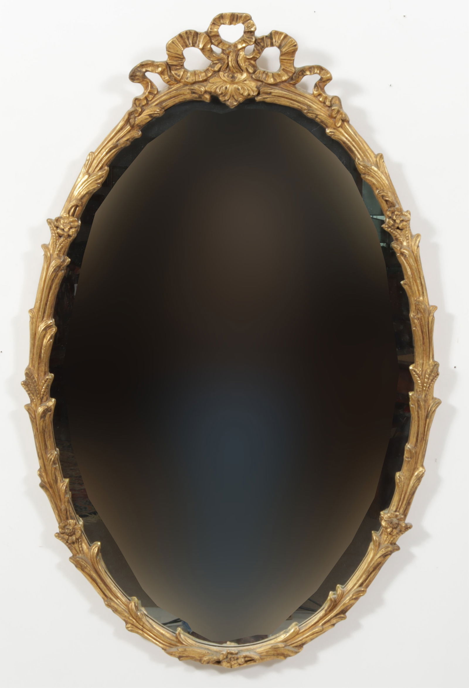 Decorative Arts, Gilt Composition Mirror: Decorative Arts Inc, Gilt Composition Mirror with bow-form crest. Dimensions: 42" H x 27" W