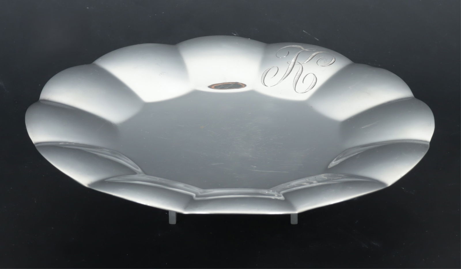 Tiffany & Co Sterling Silver Scalloped Rim Plate: Tiffany & Co sterling silver scalloped rim serving plate, script K monogram, 1946-56 date mark. Bottom stamped Tiffany & Co / Makers / Sterling Silver / 22929 / M. 16.44 OZT. Dimensions: 9.25"