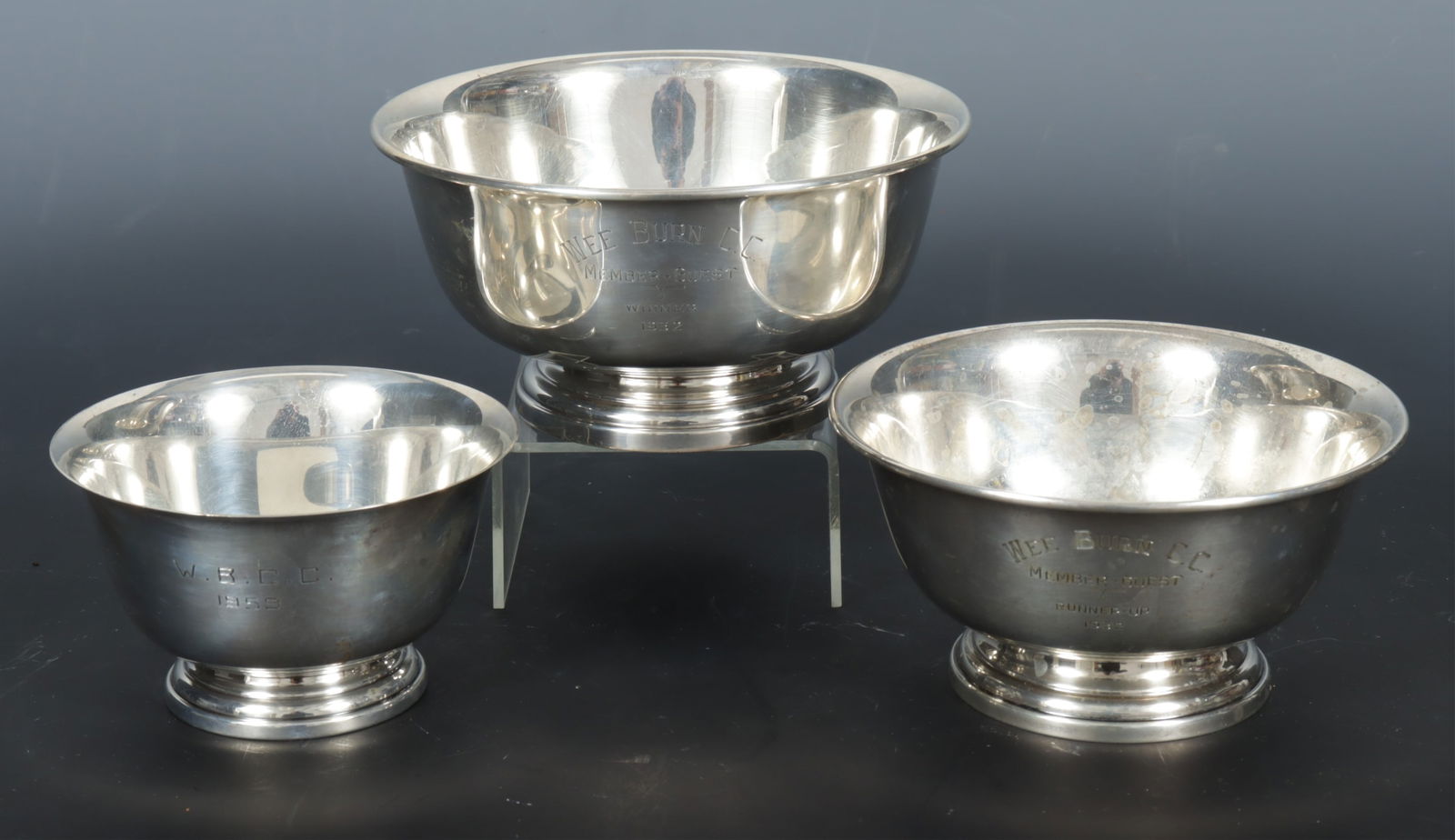 Three Preisner Sterling Silver Revere Bowls: A nest of three graduating Preisner Silver Company sterling silver Paul Revere style pedestal bowls with stepped bases. Each stamped on bottom and numbered 162, 160, and 225. 19.05 OZT. Dimensions: