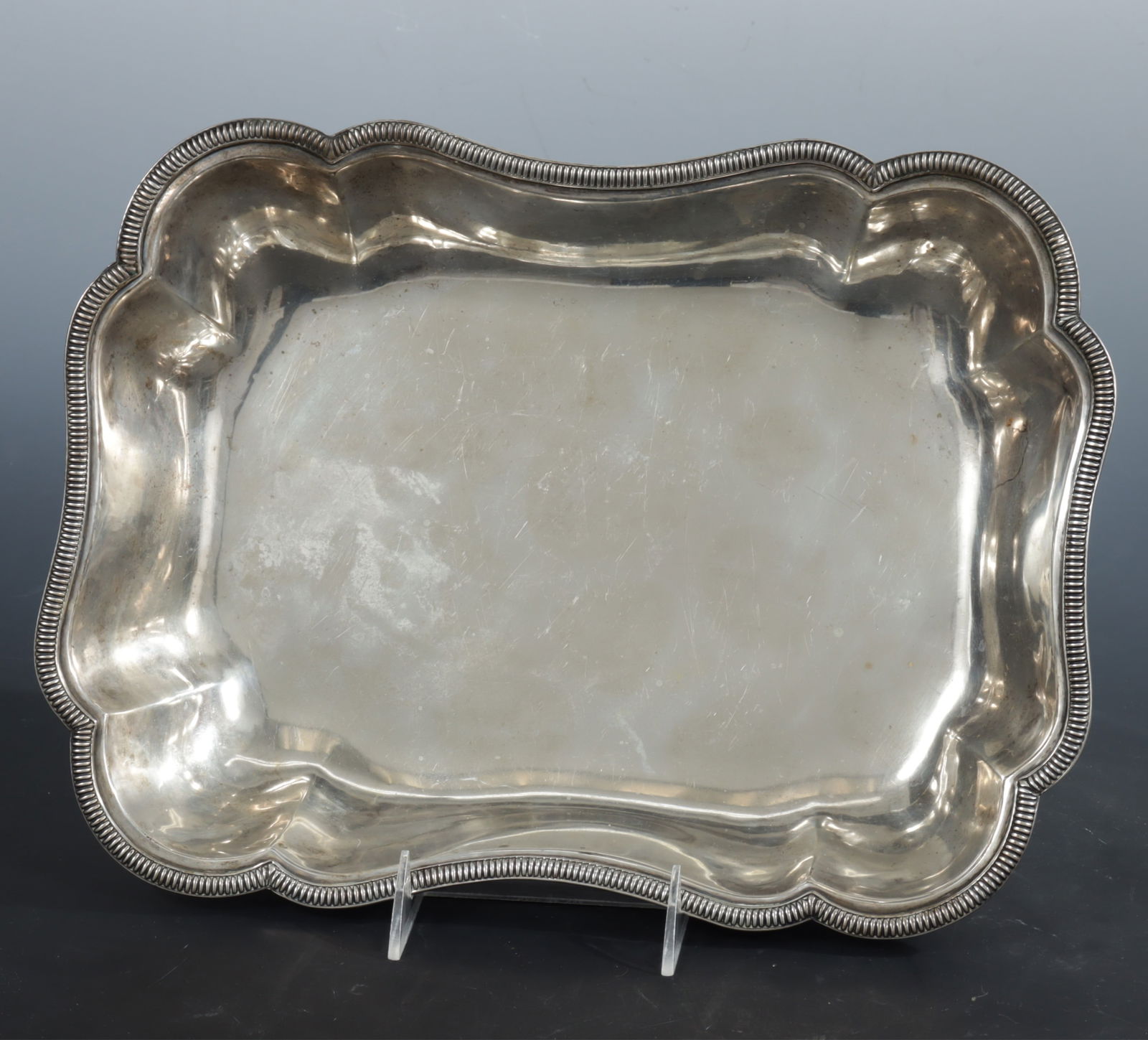 Large .800 Silver Serving Dish: Large antique .800 silver rectangular serving dish with shaped corners and reeded flange rim. Partial 8.... stamp on rim. 34 OZT. Dimensions: 13.75" x 9.75" 