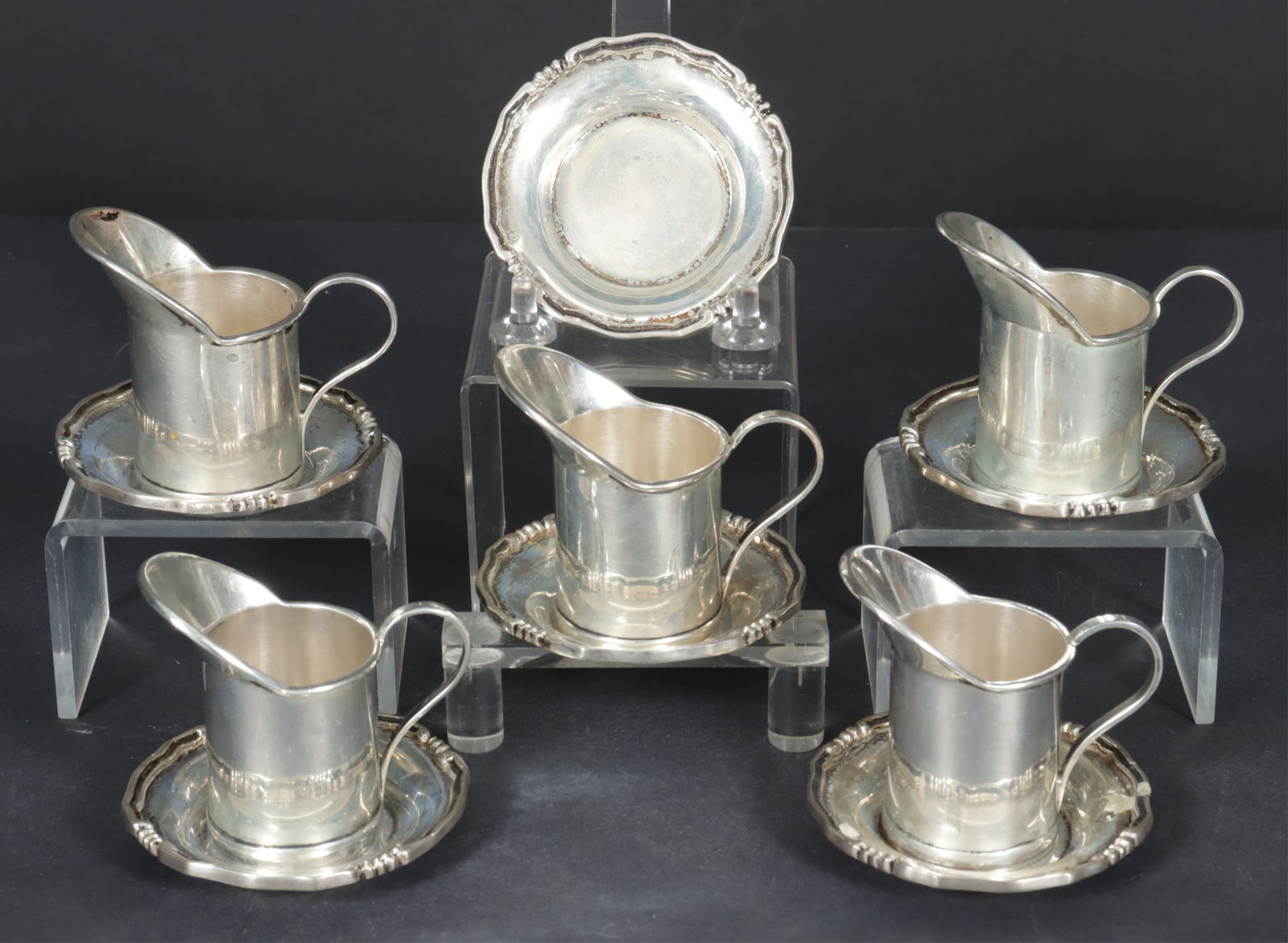 Sanborns Sterling Silver Personal Cream Jugs: Sanborns, Mexican five sterling silver personal size cream jugs with six saucers. 15.23 OZT. Dimensions: Jugs 2.5" H. Saucers 2.75" diameter. 