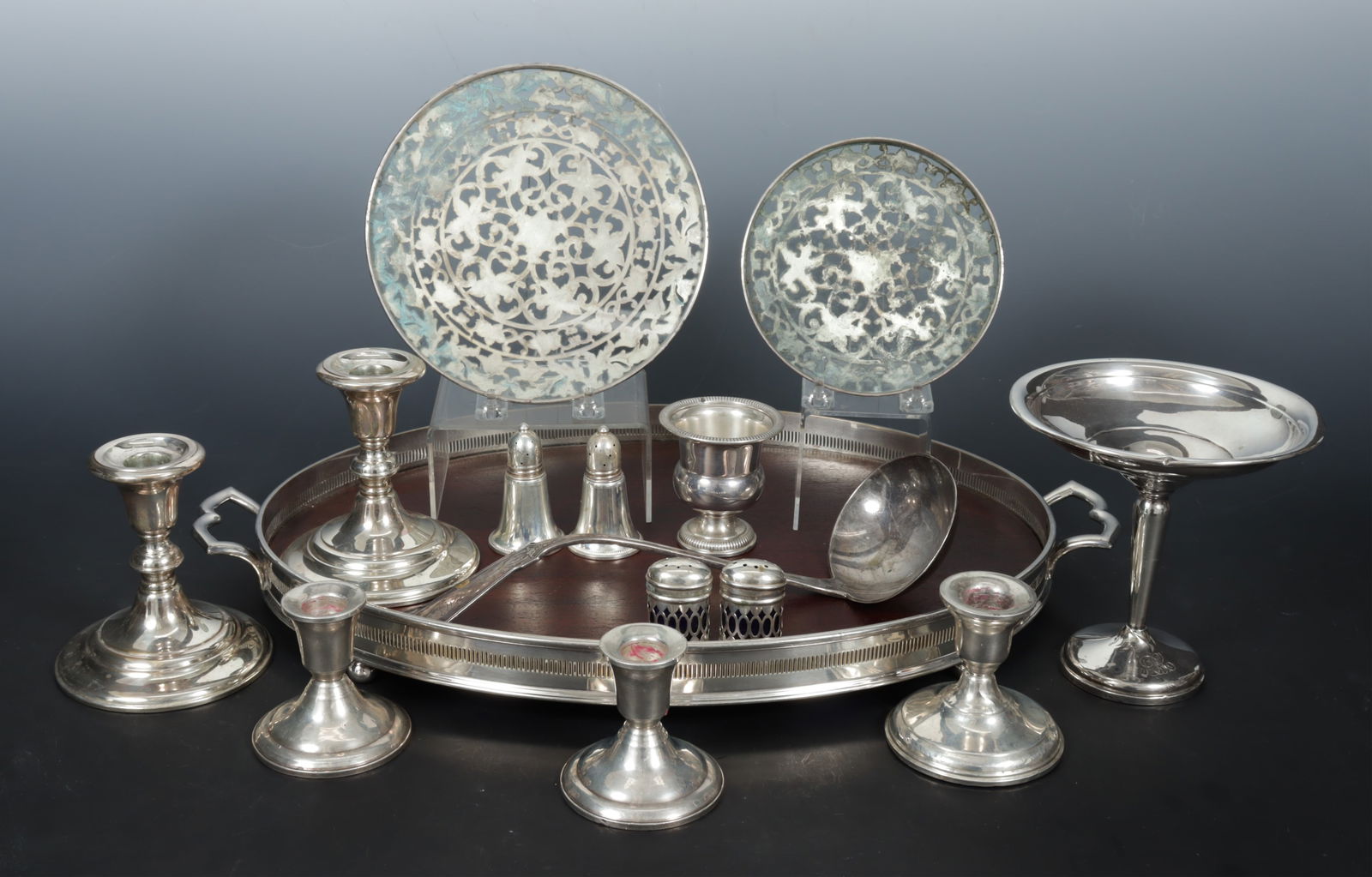 Group of Weighted Sterling Silver Tableware: A grouping of weighted and other sterling silver tableware. Comprising: tazza, pair of Black Starr & Gorham candlesticks, pair of candlesticks, single candlestick, pair of salt and pepper shakers,