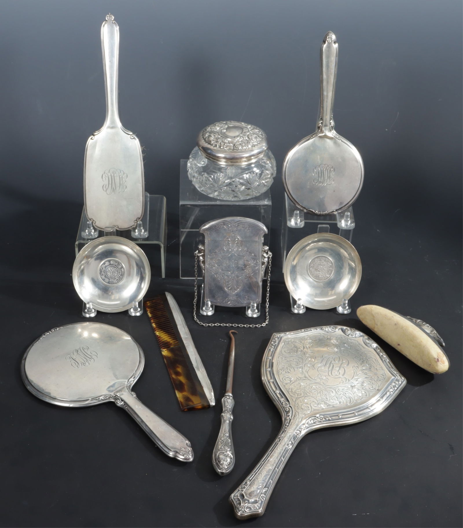 Group of Sterling Silver Vanity Items: A grouping of American sterling silver vanity items, 20th century. Comprising: Gorham card carrying case, Gorham floral repousse topped cut crystal powder jar #S2509, International paddle hair brush,
