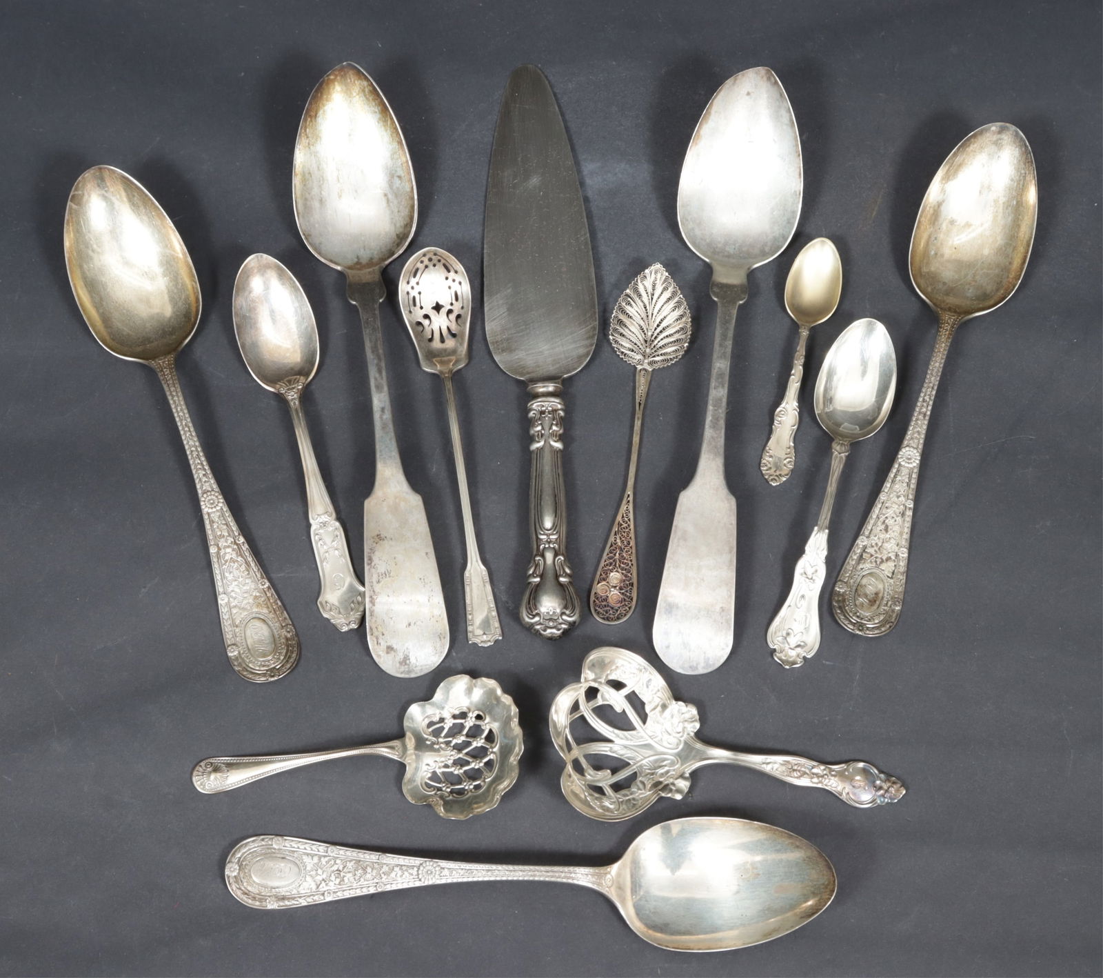 Group of Sterling Silver Flatware: A grouping of sterling silver flatware. Comprising: three large Whiting serving spoons, Whiting bon bon spoon, R Wallace bon bon spoon, four other small spoon, sterling-handled pie server, pair of