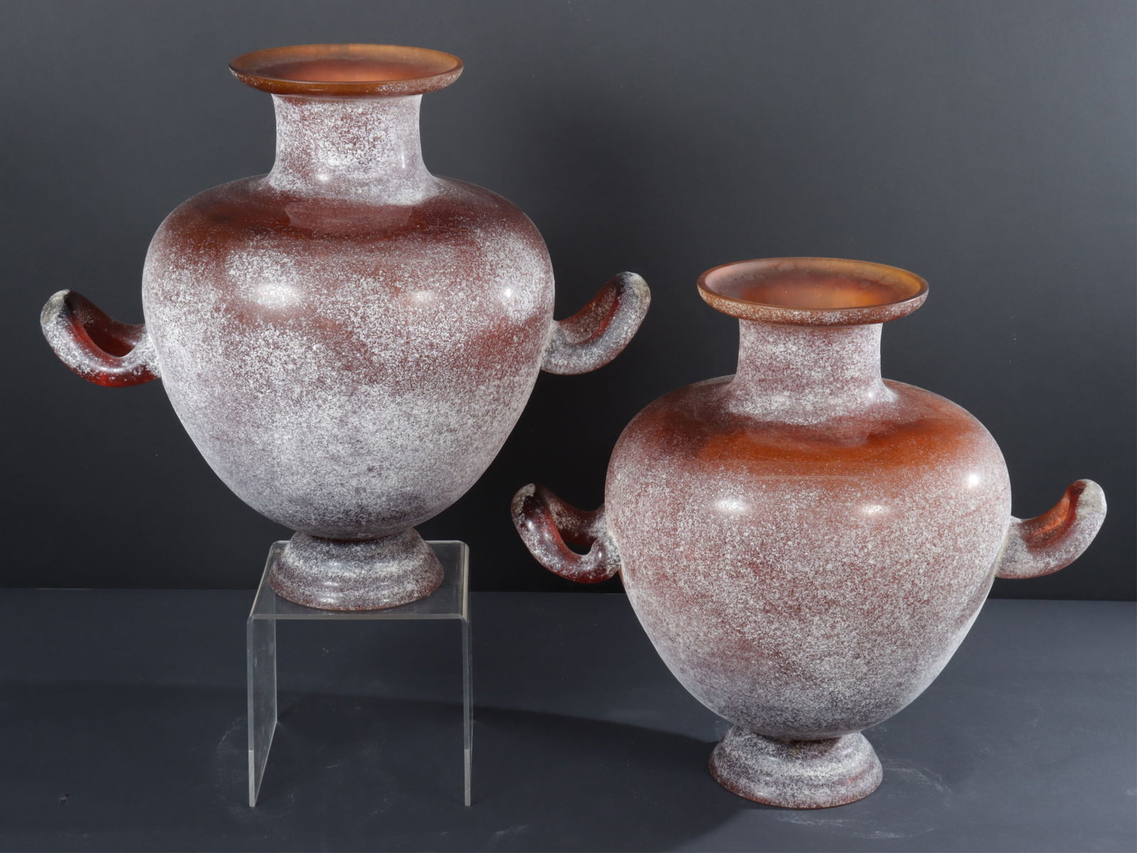 Pair Murano Seguso Vetri d'Arte Scavo Vases: Pair Murano Scavo Vases by Seguso Vetri d'Arte. amber glass with textured surface. One once labeled (label off but retained) Dimensions: 15" H x 17" W across handles x 12" D