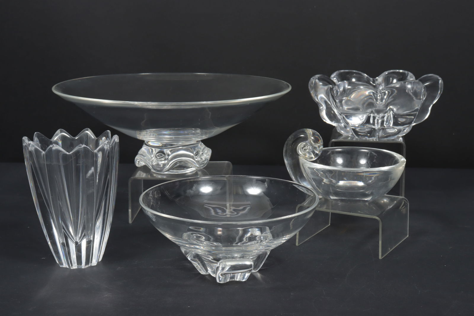 Group of Steuben and Orrefors Glass Tableware: Group of Steuben and Orrefors Glass Tableware. Comprising: Orrefors fluted vase and abstract bowl, three Steuben bowls. Dimensions: Largest 4.5" H x 12.5" diameter