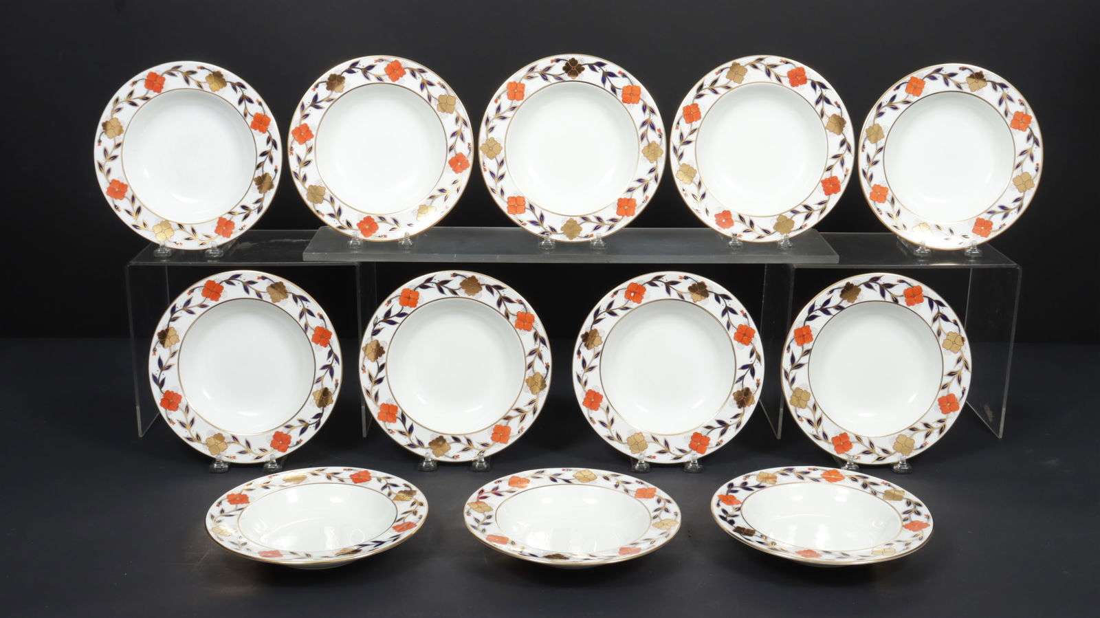 12 Royal Crown Derby Tiffany & Co Asian Rose Bowls: A group of 12 Royal Crown Derby for Tiffany & Co porcelain Asian Rose soup bowls. Sienna and gilt flowers with gilded cobalt leaves, gilt rims. Dimensions: 8 1/8" diameter