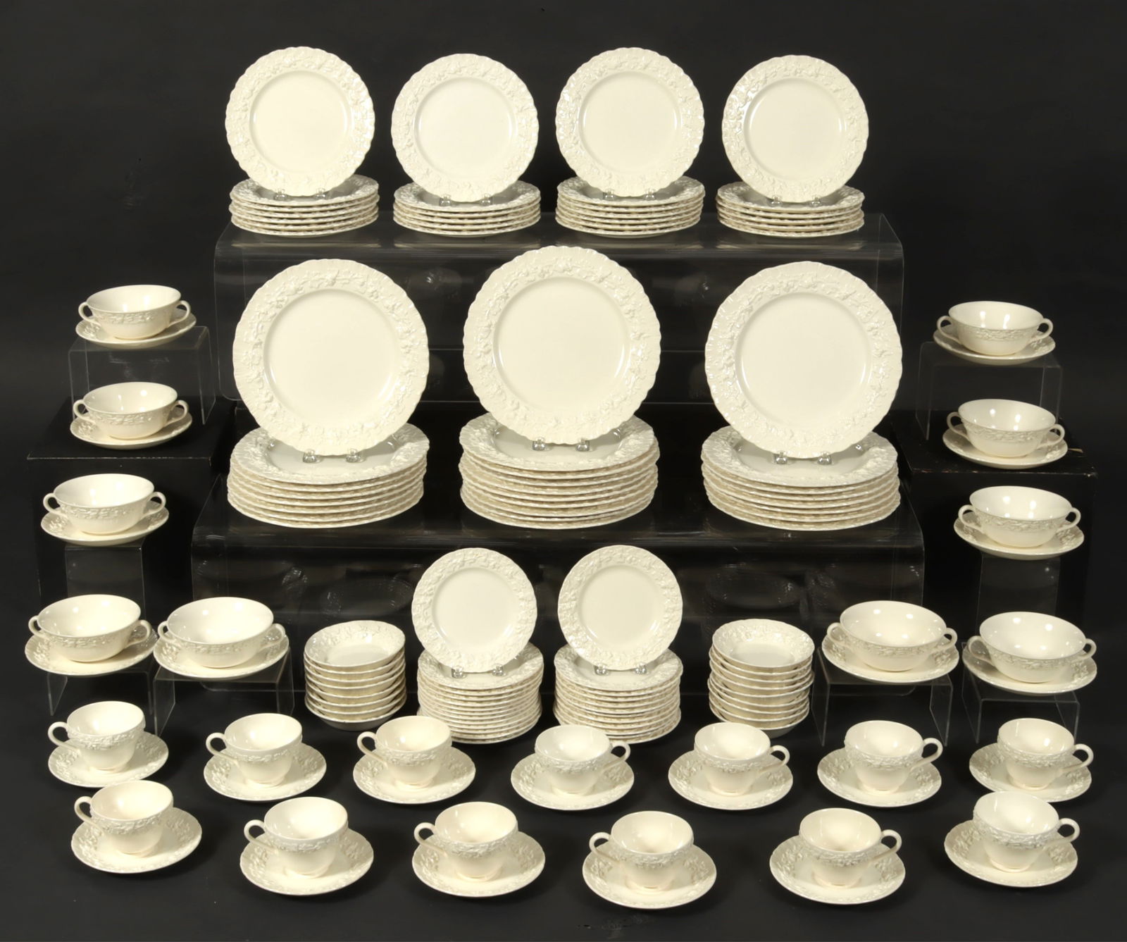 Wedgwood Queensware Dinner Service: Wedgwood Queensware assembled earthenware dinner service. Comprising: 26 dinner plates, 26 salad plates, 25 bread plates, 17 bowls, 19 two-handle soups with 20 saucers, 26 cups with saucers. 183 piece