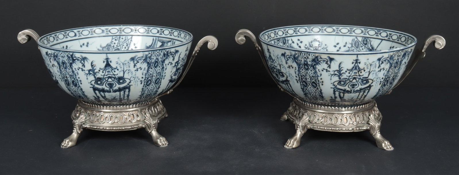 Pair Blue & White Porcelain Bowls: Pair of blue and white porcelain bowls with metal settings. Dimensions: 8.25" H x 16.5" W Property from a Bronxville Estate.
