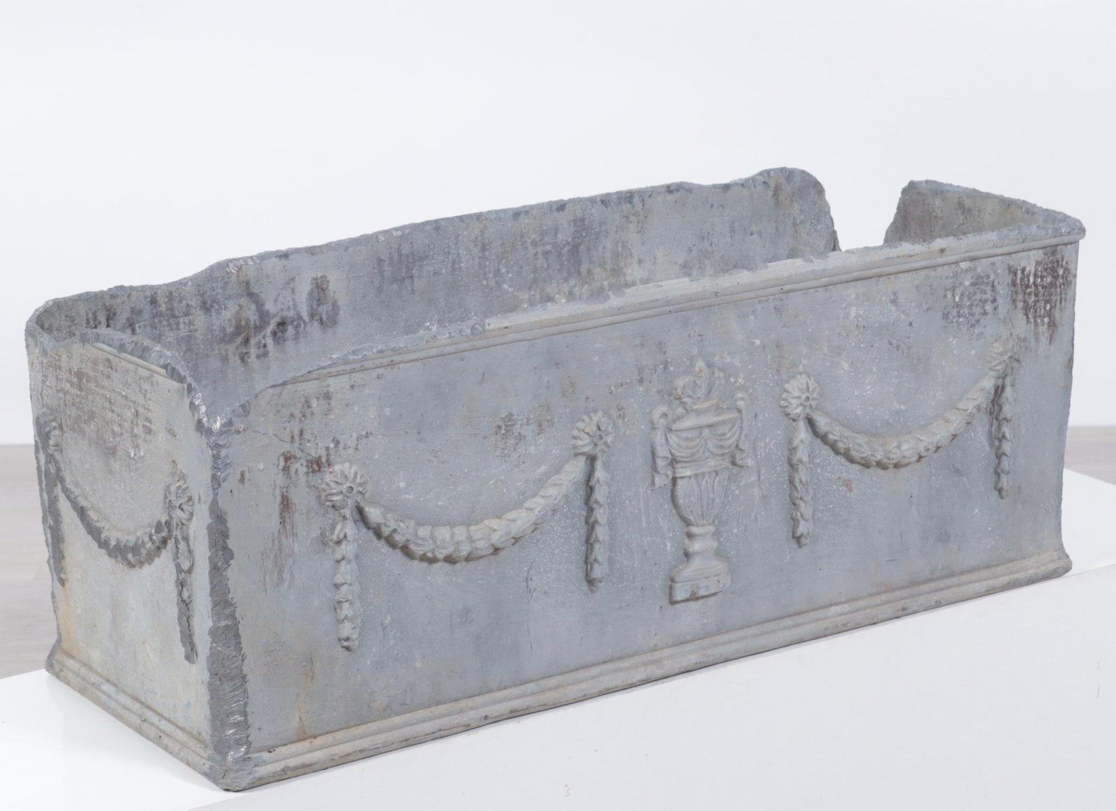 English Classical Style Cast Lead Planter: English classical style cast lead planter decorated with laurel swags. Dimensions: 9.5" H x 25.5" W x 10" D