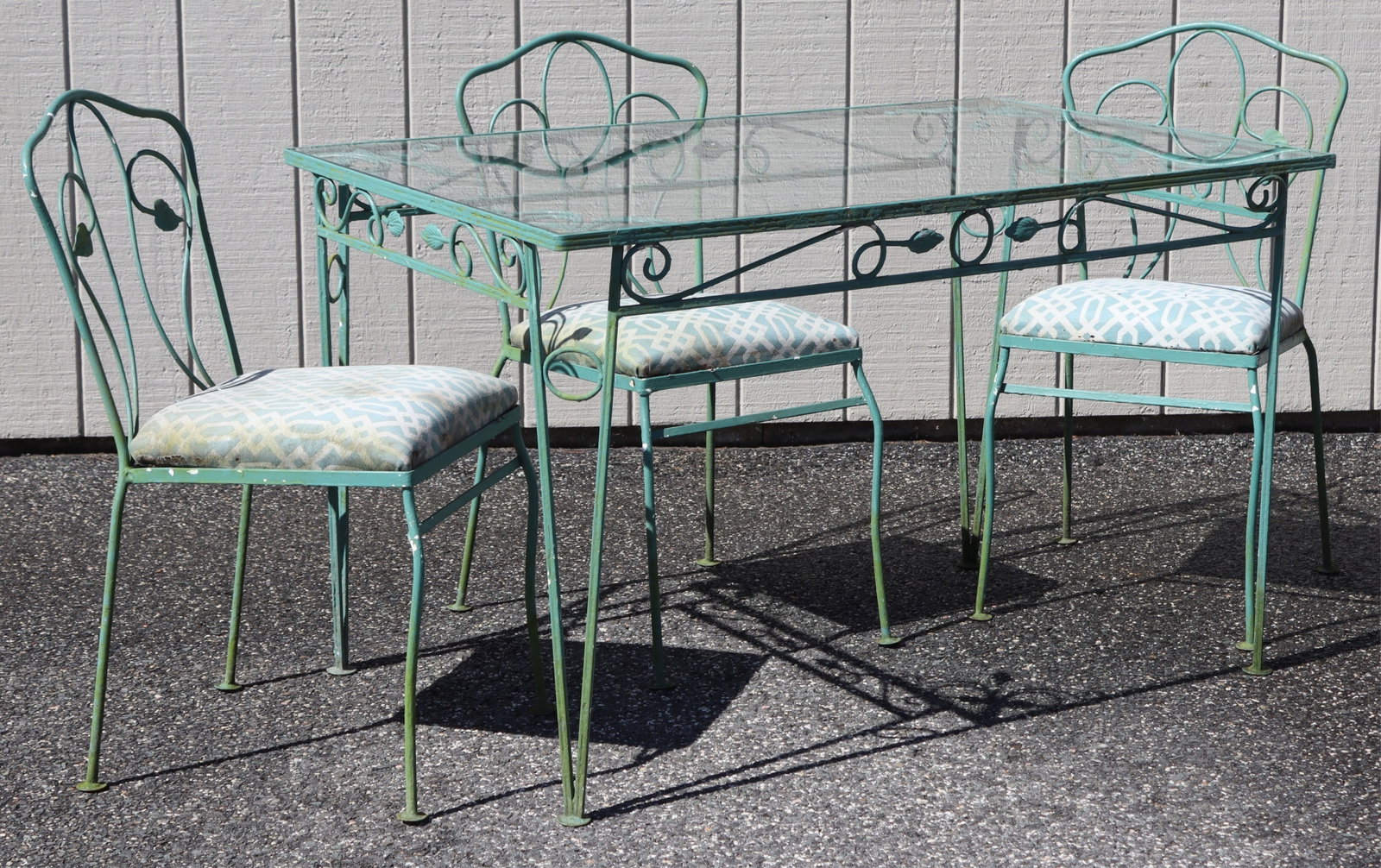 Russell Woodard Iron Table & Chairs: Russell Woodard green painted iron table and three chairs Dimensions: Table 29.5" H x 30.5" W x 48.5" L Property from a Connecticut shoreline home