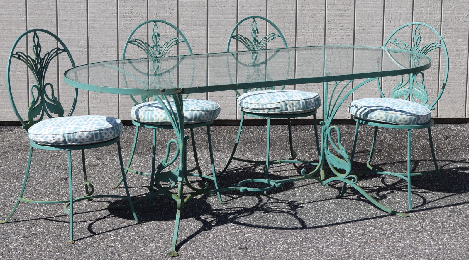 Russell Woodard Iron Swan Table & Chairs: Russell Woodard green painted iron swan motif table and four chairs. Dimensions: Table; 72.5" L X 32.5" W X 28.5" HChairs; 34" H X 16" D X 16" W Property from a Connecticut shoreline home