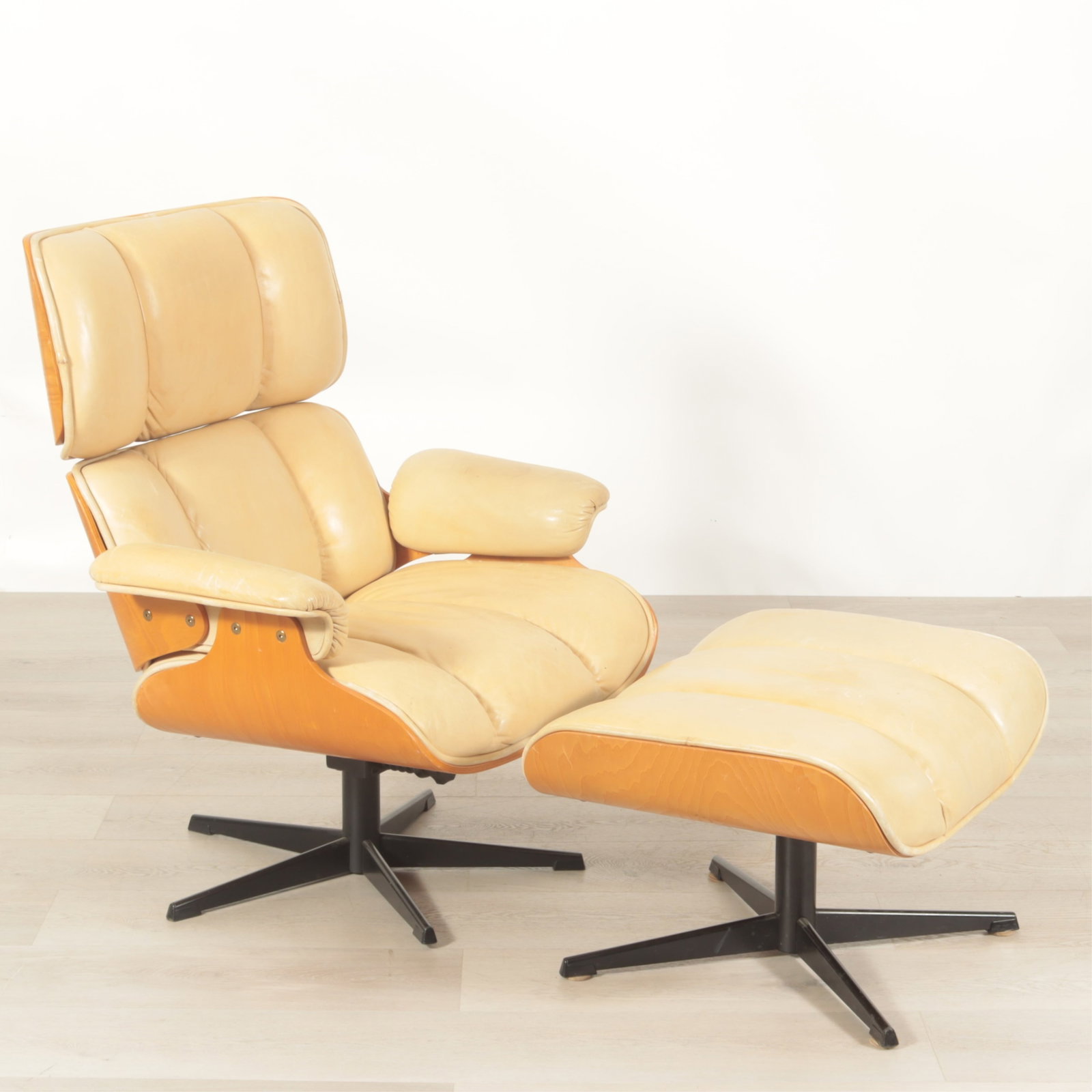 Eames Style Ash Lounge Chair & Ottoman: Eames Style Ash Lounge Chair & Ottoman, upholstered in cream leather Dimensions: Chair 38.5" H x 33.25" W x 30" D, Ottoman 16.25" H x 26.25" W x 21.5" D