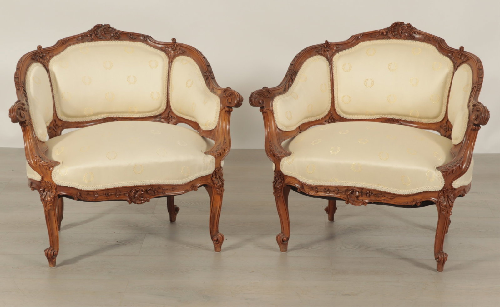 Pair of Louis XV Style Bergere Marquise: Pair of Louis XV style carved cherry bergere marquise, wood carved scroll, shell and floral motifs, tripartite back, gimp trim, cabriole legs, upholstered in a neoclassic laurel wreath pattern fabric 