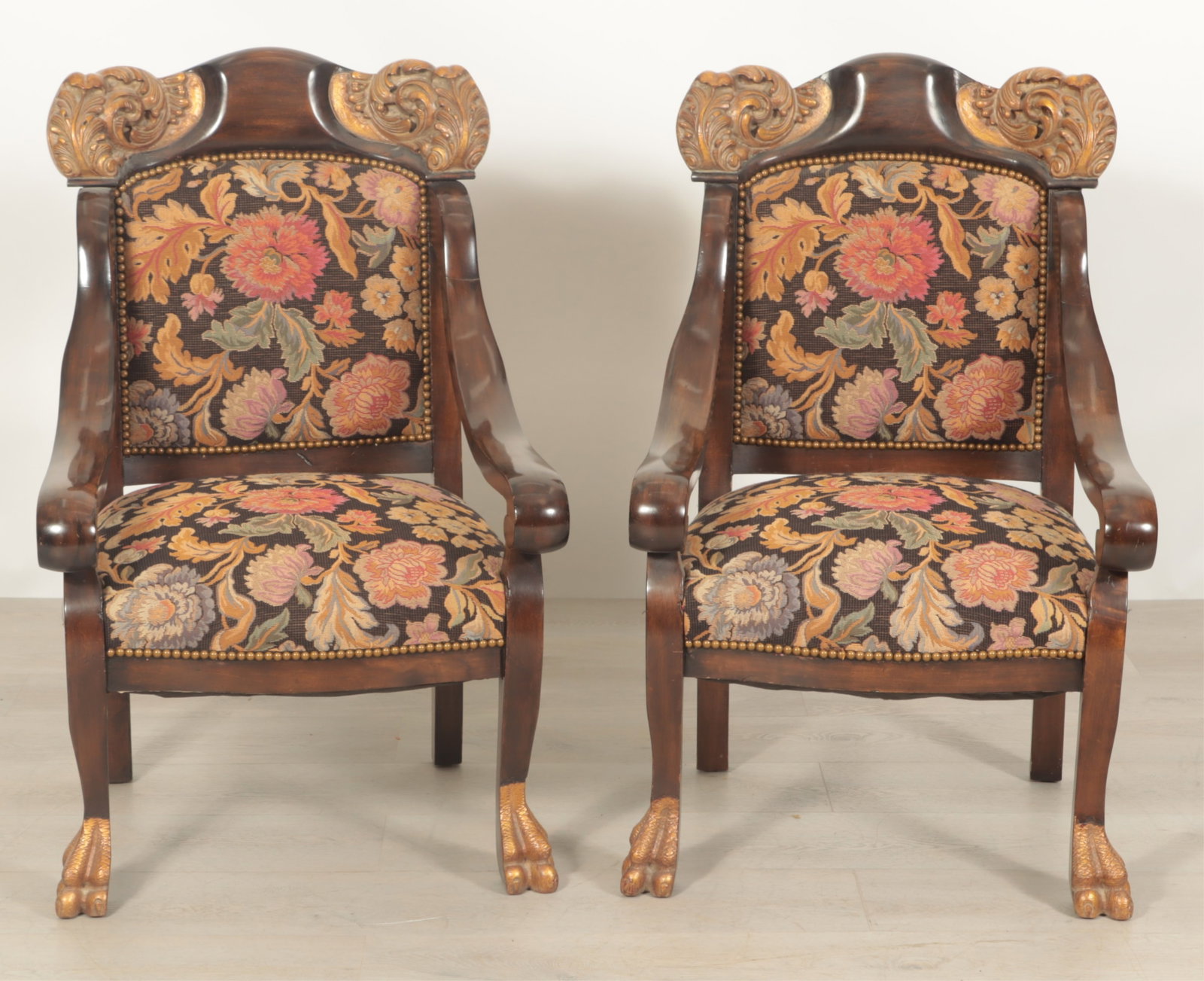 Pair of Rococo Style Mahogany Armchairs: Pair of Rococo Style Parcel-Gilt Mahogany Armchairs, upholstered in brass tacked foliate machined needlepoint. Dimensions: 40.25" H x 25.5" W x 27" D Property from a Bronxville Estate.