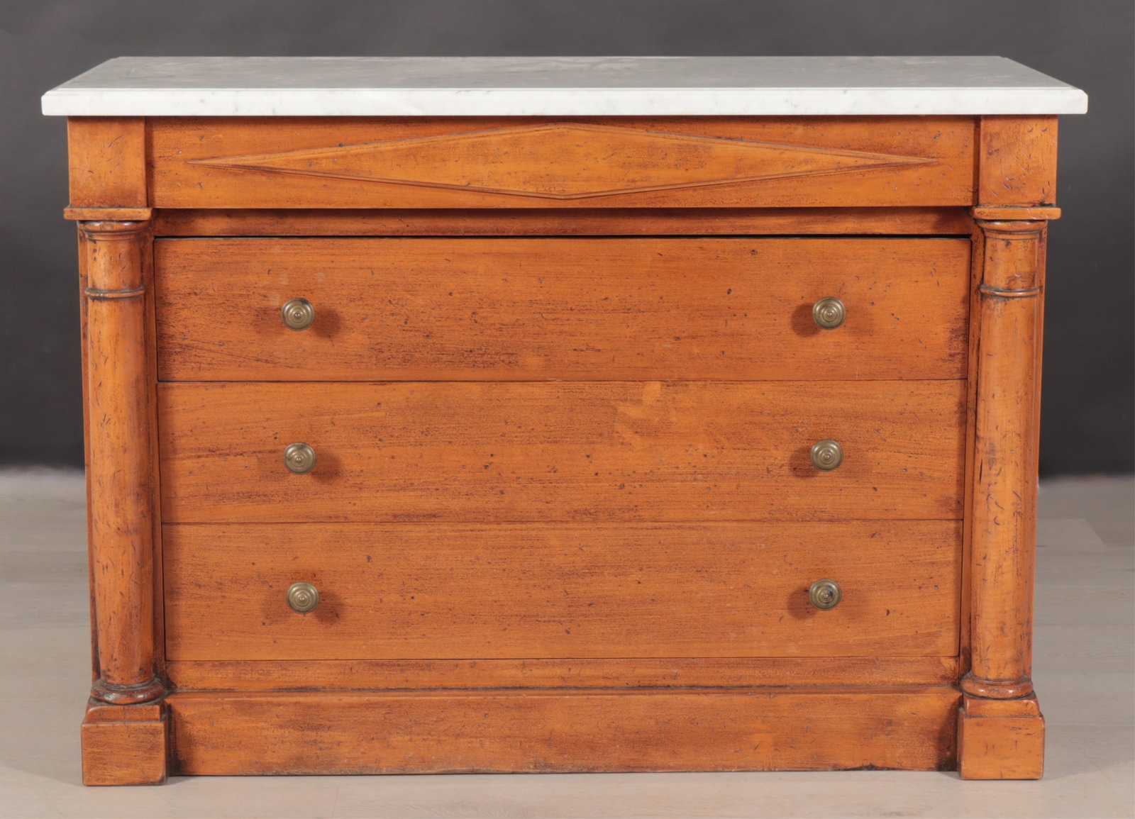 Italian Directoire Style Cherry Commode: Directoire style cherry commode with white marble top and paper lined drawers. Stamped Made in Italy. Dimensions: 33.25" H x 47" W x 19.75" D