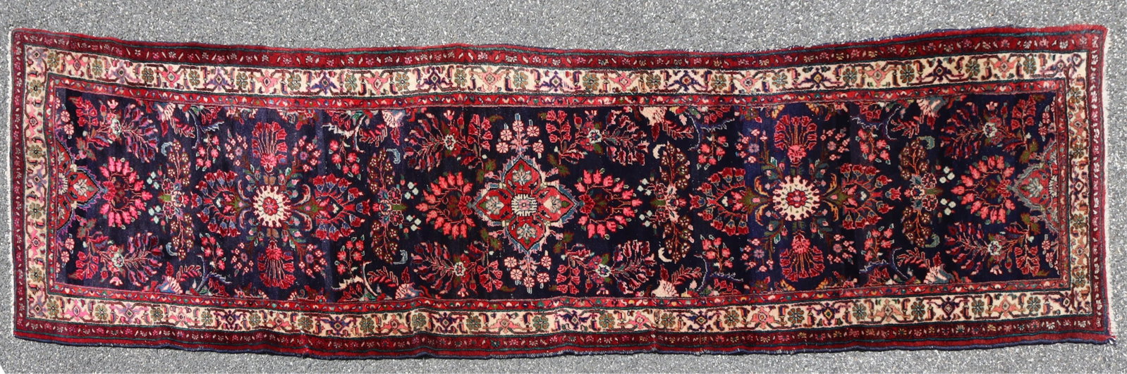 Sarouk Wool Runner Rug 3-10 x 12-6: Sarouk hand knotted wool runner rug, field navy blue ground, abrash, center medallion with red ground, floral and vine scroll pattern throughout Dimensions: 3-10 x 12-6