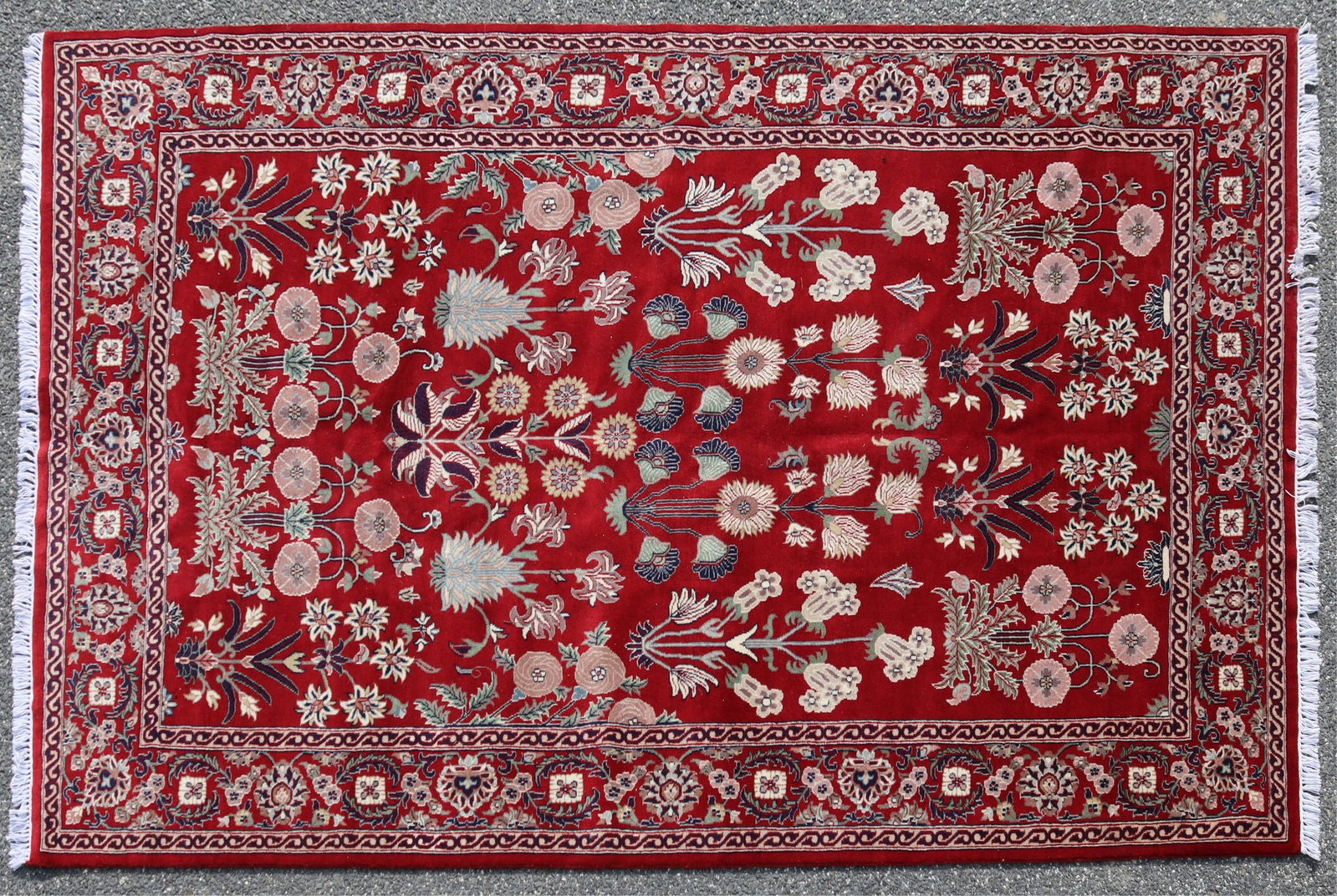 Tabriz Style Wool Rug 6-1 x 9-0: Tabriz style wool rug with crimson red ground throughout, vase and floral gol-farangi pattern repeating flowering tree and palmettes. Dimensions: 6 feet 1 inch x 9 feet Property from a Washington