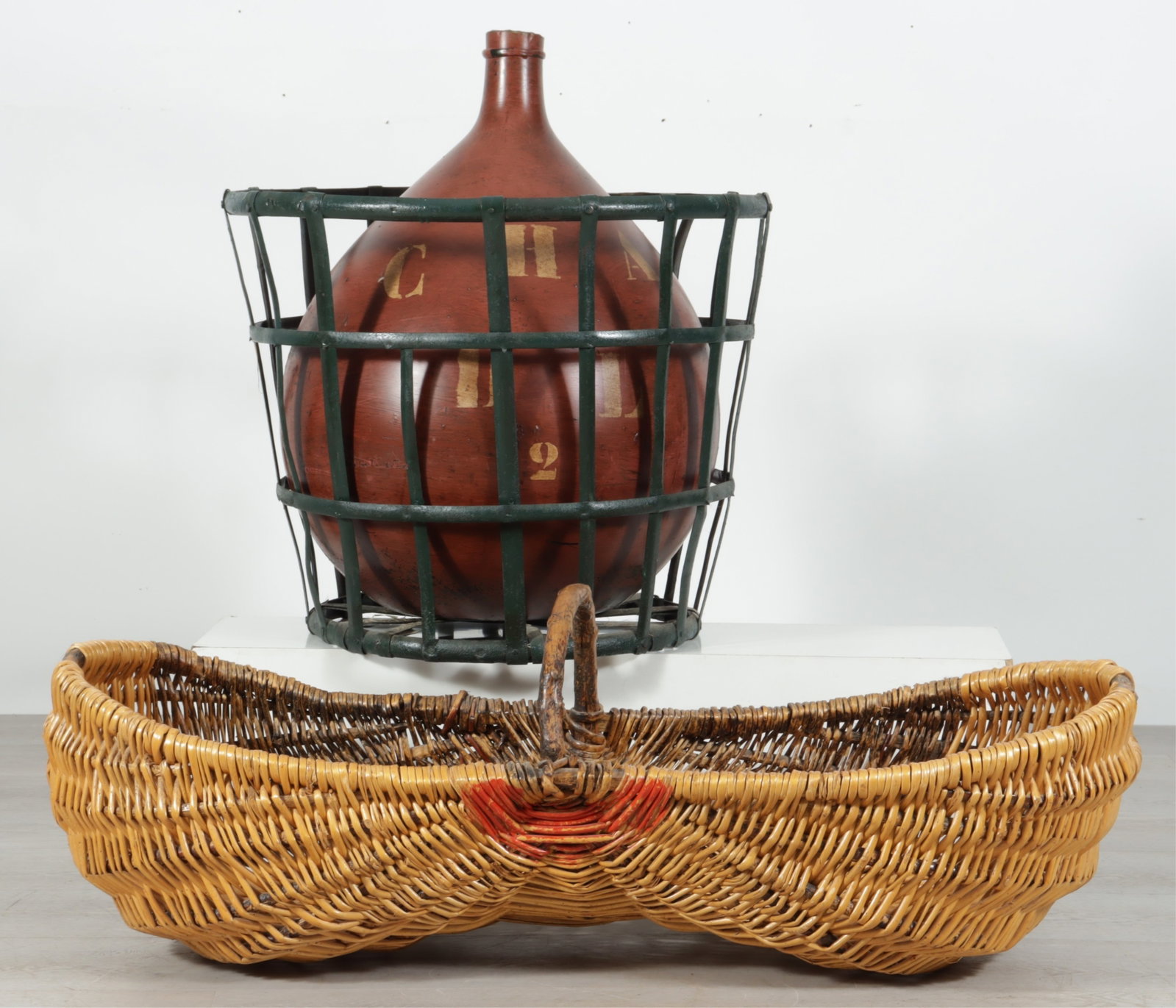 French Burgundy Wine Jug & Grape Harvesting Basket: Early 20th C. French Burgundy wine jug, painted and stenciled "1912 BEAUNE - CHA-DL-2" along with a rattan and twig peanut shaped grape harvesting basket