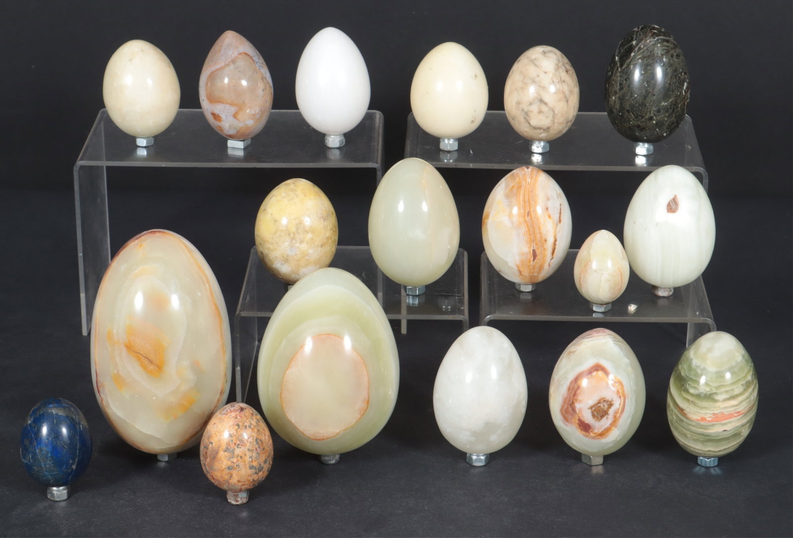 Group of Hardstone Egg Specimens: A grouping of 18 various hardstone egg specimens, including green onyx, rhyolite, calcite, lapis, etc.