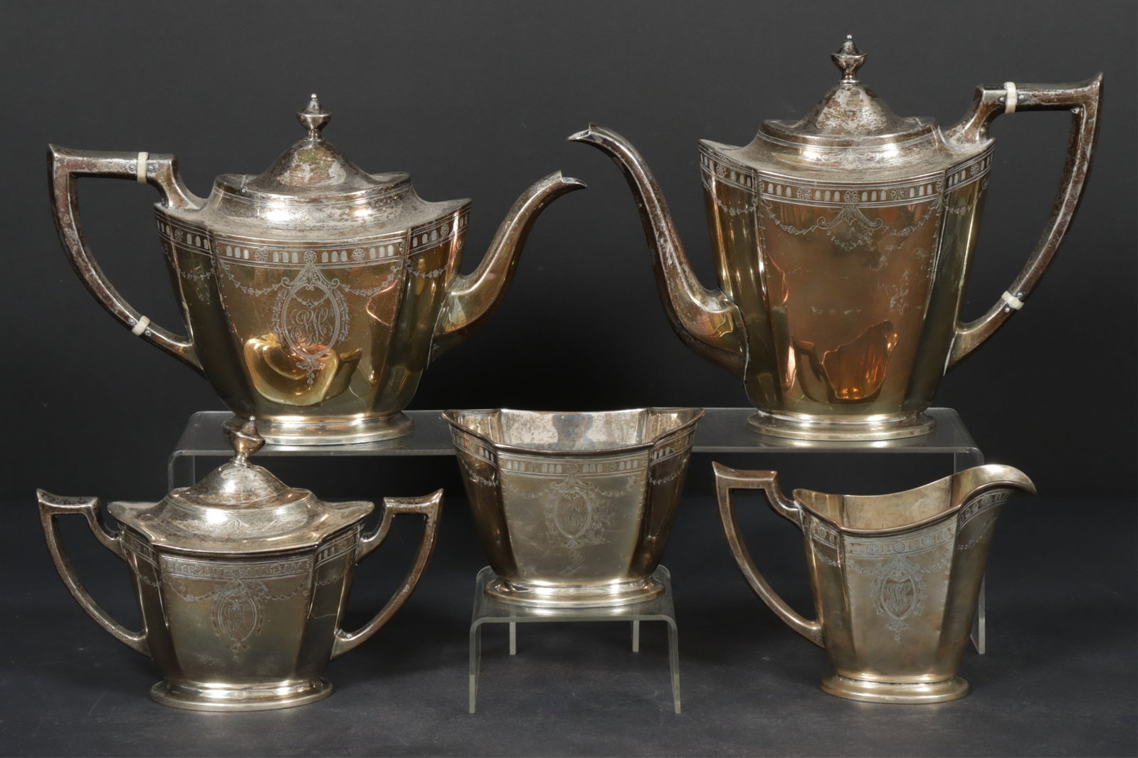 Jennings Silver Co. Sterling Coffee & Tea Service: Jennings Silver Co., early 20th century 5-piece sterling silver coffee and tea service. Comprising: 3 pint coffee pot, 2 1/2 pint teapot, covered sugar, creamer, and waste bowl. Pattern number 1400.