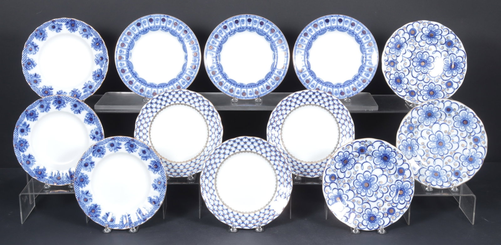 12 Lomonosov Gilt Porcelain Dessert Place: A group of 12 Lomonosov cobalt blue and gilt porcelain dessert places. Four patterns with three plates each.